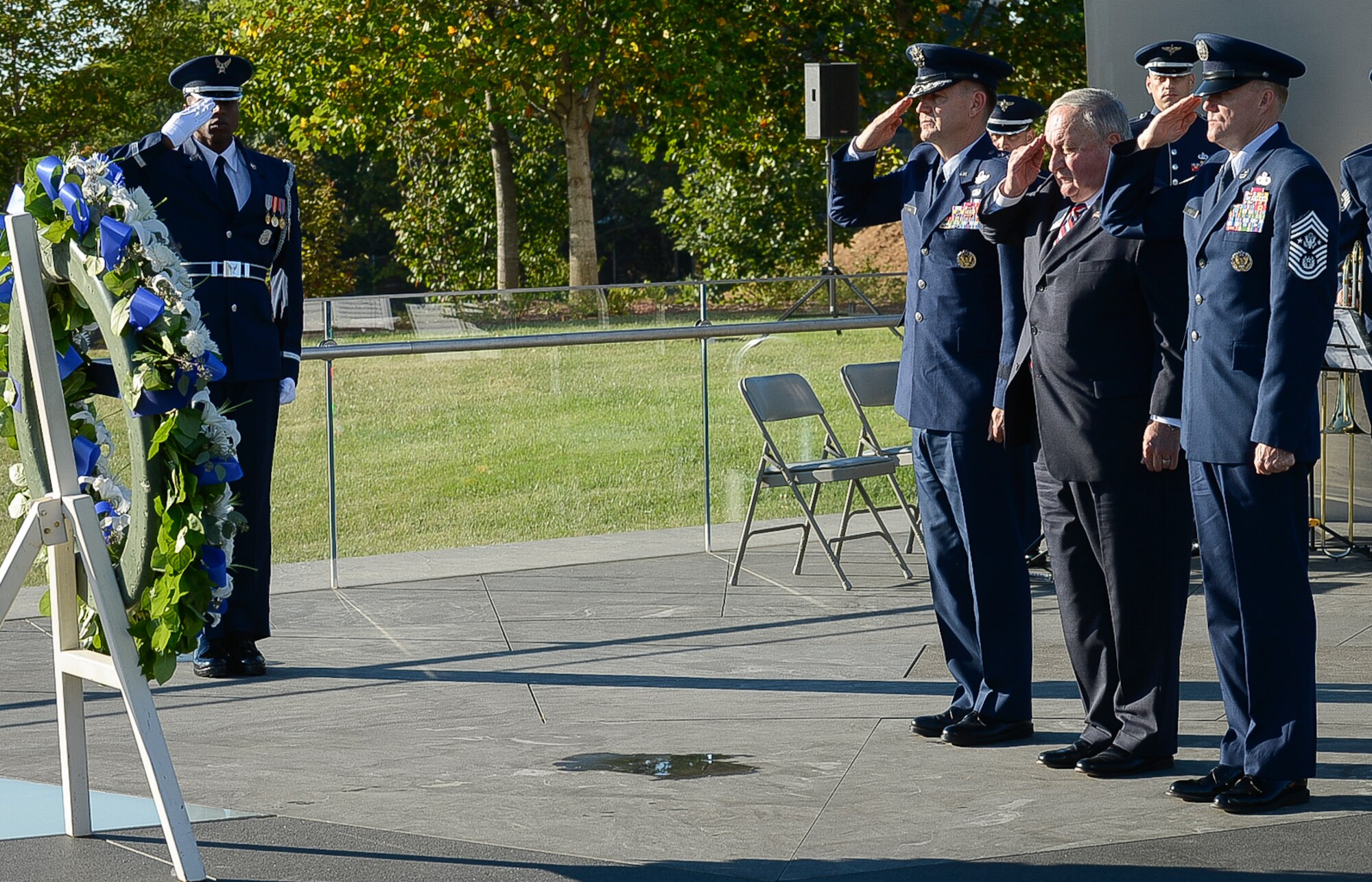 Air Force Assistant Vice Chief of Staff Lt. Gen. Stephen Hoog (left),  Air Force Association Chairman of the Board Mr. George Muellner and Chief Master Sergeant of the Air Force James Cody render honors after laying a wreath during a memorial service Sept. 15, 2013, at the Air Force Memorial, Arlington, Va. The Air Force's 12 Outstanding Airmen of the Year, Air Force Senior Leaders and Air Force Association members were on hand for the early morning service. (U.S. Air Force photo/Jim Varhegyi)