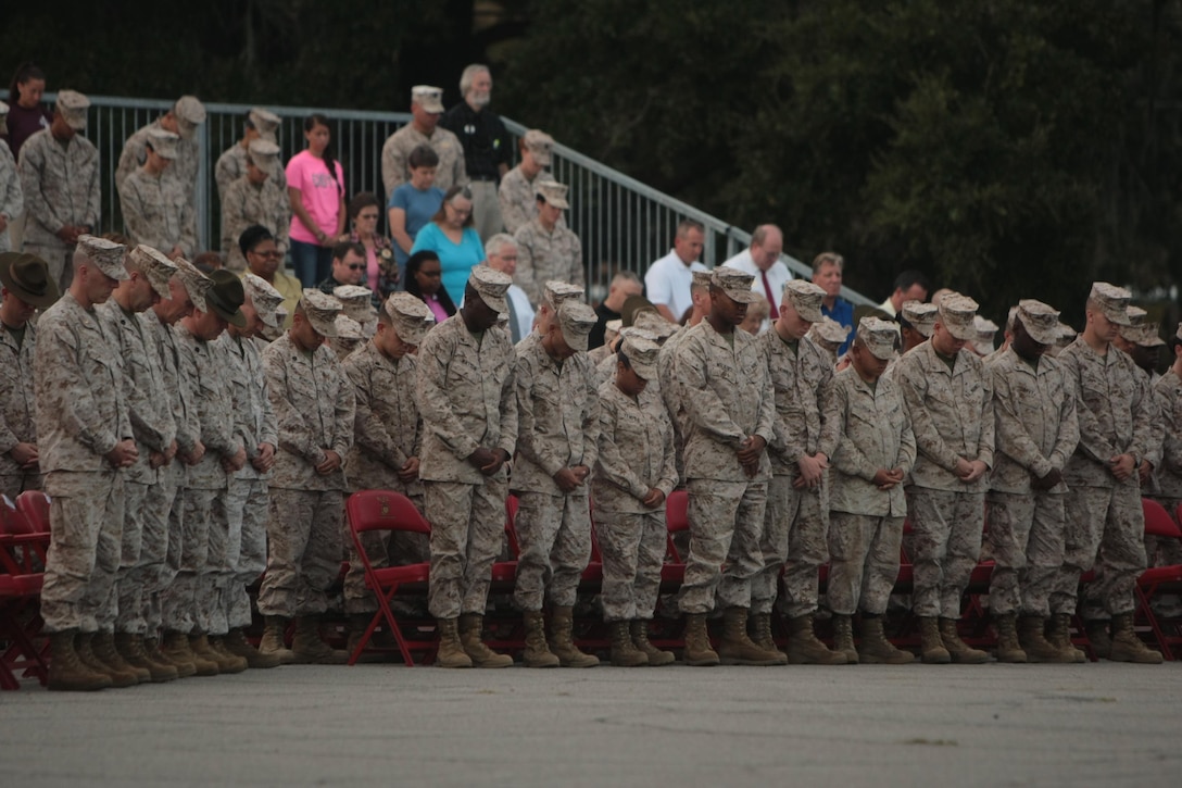 Marines from across Parris Island, S.C., bow their heads Sept. 11, 2013, during a moment of silence as part of a commemorative ceremony dedicated to the lives lost on 9/11. Terrorist attacks 12 years ago killed approximately 3,000 people, making it the greatest tragedy on U.S. soil since the Japanese attack on Pearl Harbor in 1941. (Photo by Cpl. Caitlin Brink)