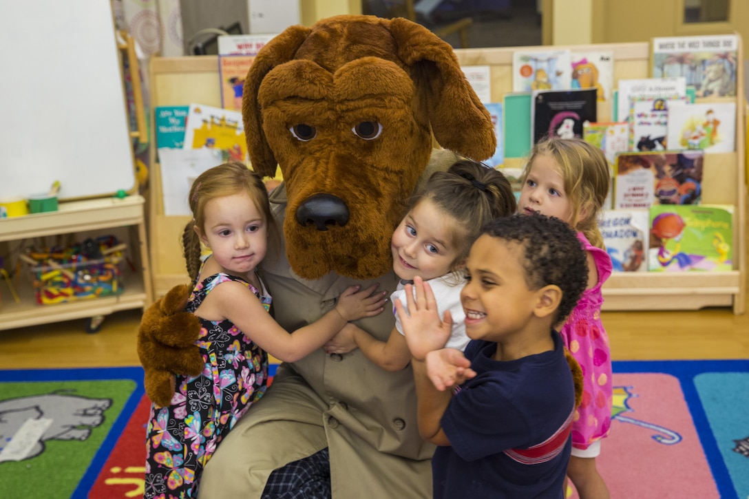 McGruff the Crime Dog visits the children of Marine Corps Air Station Yuma, Ariz., while they attend the child development center, Thursday. McGruff is a cornerstone of the National Crime Prevention Association. More than 75 percent of children recognize McGruff, and over 4,000 law enforcement agencies own a McGruff suit; this McGruff calls the Provost Marshals Office home. "Take A Bite Out Of Crime!"