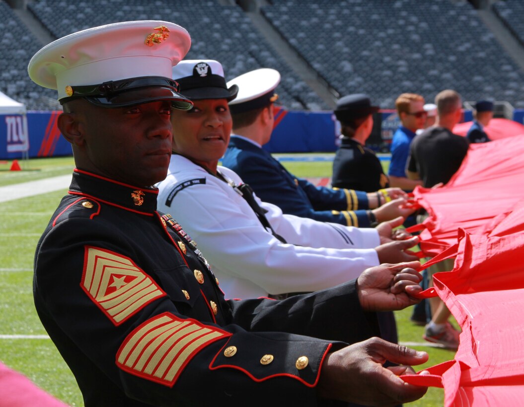 EAST RUTHERFORD, N.J. - Sgt. Maj. Samuel Heyward Jr., the sergeant major of the 1st Marine Corps District, pulls on an American flag during rehearsals prior to the Broncos vs. Giants game Sept. 15.  Heyward brought along four other 1MCD Marines to participate in the pre-game ceremonies of what was labeled the “Manning Bowl.”  (U.S. Marine Corps photo by Staff Sgt. Juan Vara).