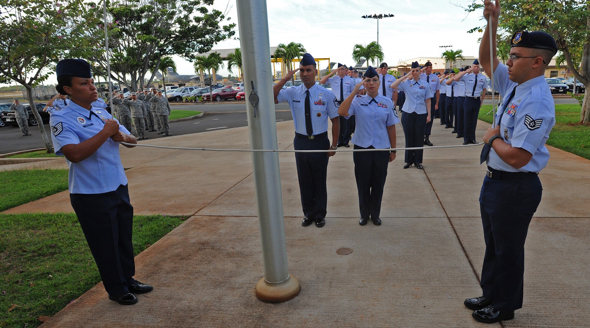 From left to right, Tech. Sgt. Chantell Bowser, 15th Wing Professional Military Education instructor, Master Sgt. John Marquez, 15 WG PME instructor, Master Sgt. Rebecca Pash, 647th Force Support Squadron base career advisor, and Staff Sgt. Reese Stock, 647th Security Forces Squadron NCO in Charge of supply, raise the U.S. flag, along and the prisoner of war/missing in action flag, during reveille ceremony at the Binnicker PME center, Joint Base Pearl Harbor-Hickam, Hawaii, Sept. 16, 2013. The week long recognition will conclude Sept. 20, 2013 with a special remembrance ceremony where U. S. Air Force (retired) Col. Henry P. Fowler Jr. and former POW during the Vietnam War from 1967-1973 will be the guest speaker at the event. (U.S. Air Force photo/Tech. Sgt. Jerome S. Tayborn)