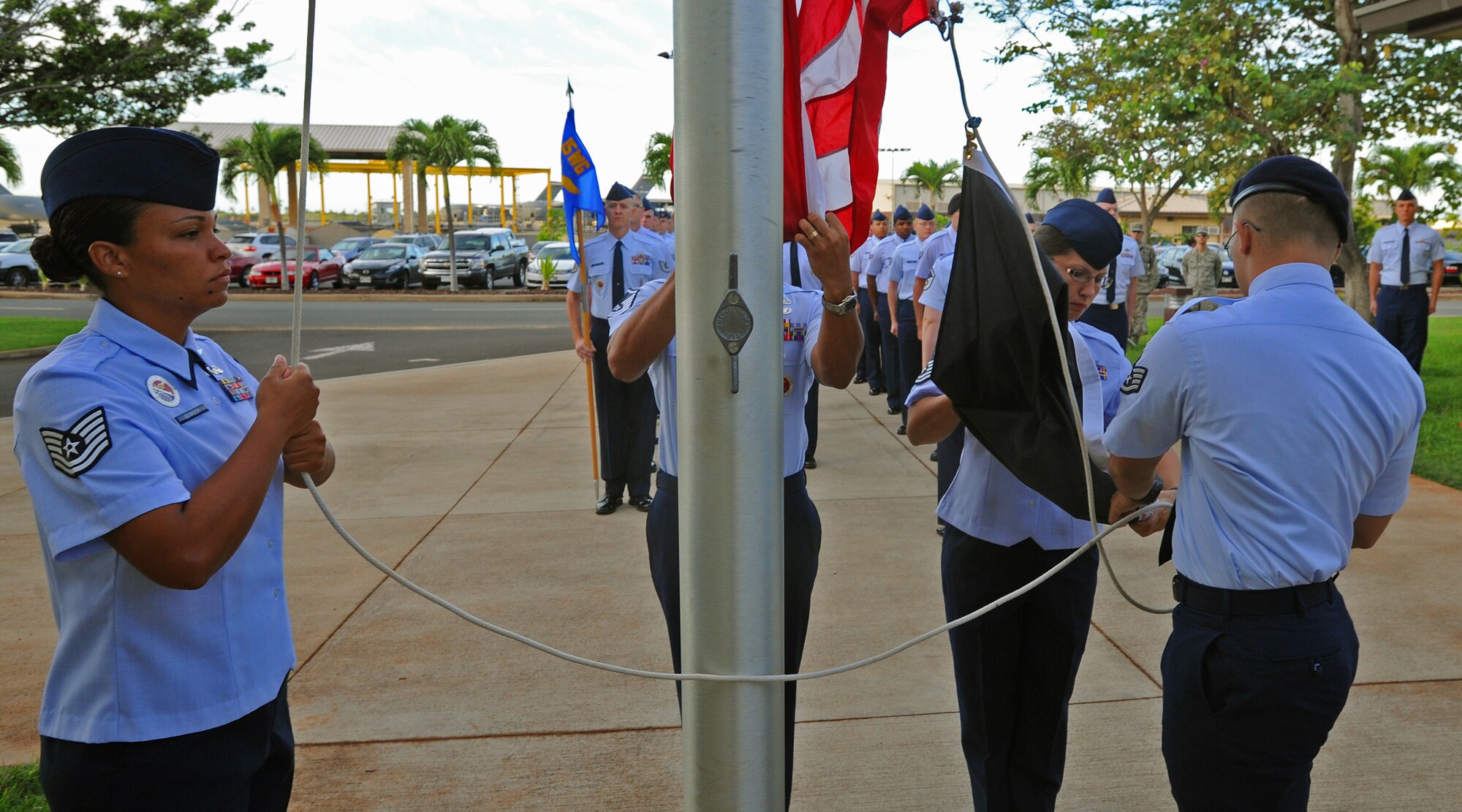 From left to right, Tech. Sgt. Chantell Bowser, 15th Wing Professional Military Education instructor, Master Sgt. John Marquez, 15 WG PME instructor, Master Sgt. Rebecca Pash, 647th Force Support Squadron base career advisor, and Staff Sgt. Reese Stock, 647th Security Forces Squadron NCO in Charge of supply, prepare to raise the U.S. flag, along with the prisoner of war/missing in action flag, during reveille at the Binnicker PME center, Joint Base Pearl Harbor-Hickam, Hawaii, Sept. 16, 2013. JBPHH is highlighting POW/MIA week with a remembrance ceremony where a former Vietnam War Veteran and POW will be the guest speaker at the ceremony scheduled for 0720 at Atterburry Circle on Sept. 20, 2013. (U.S. Air Force photo/Tech. Sgt. Jerome S. Tayborn)
