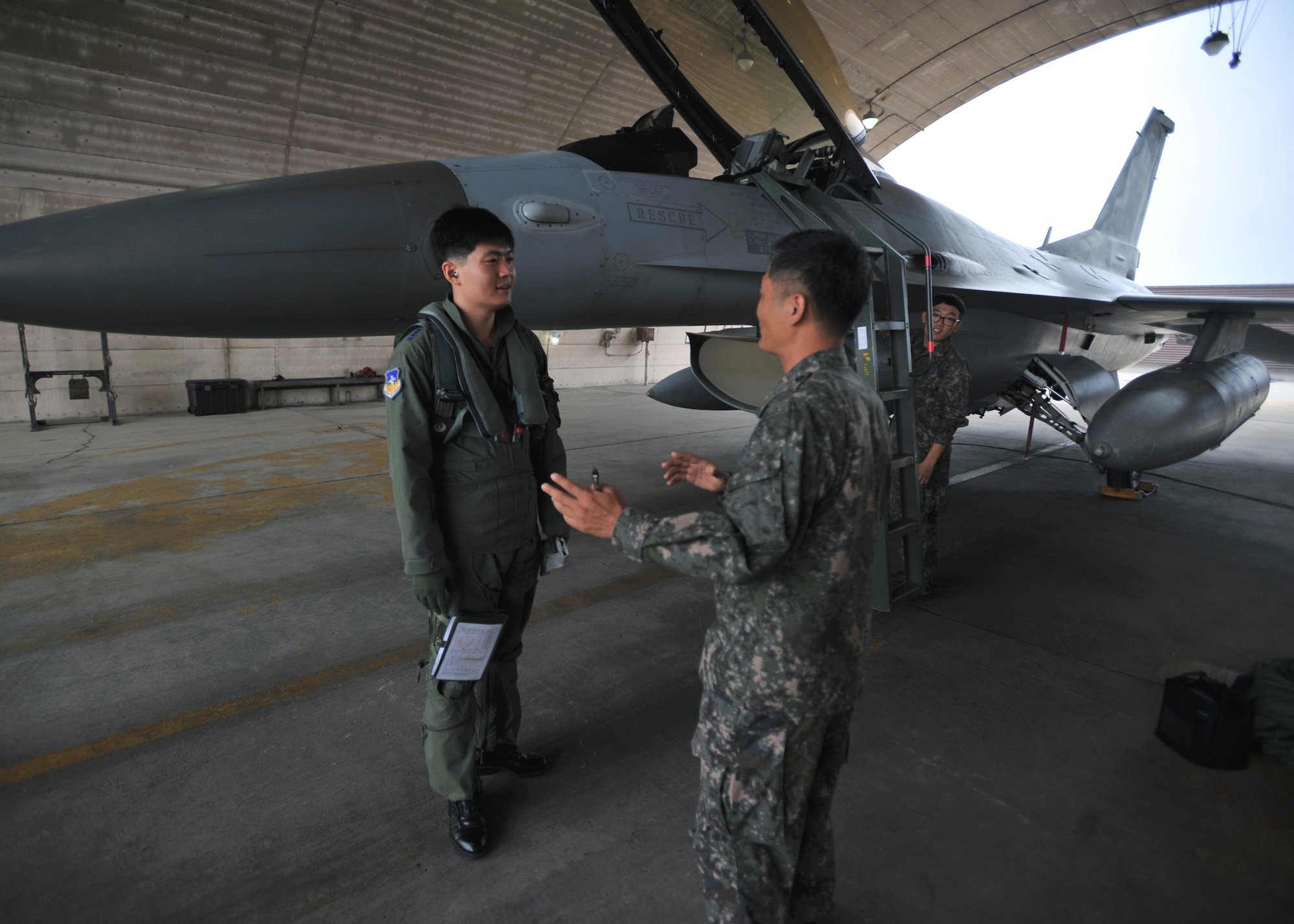 Republic of Korea air force Capt. Woo Chan Yang, a pilot with the 161st Fighter Squadron from Jungwon Air Base, Republic of Korea, receives a pre-flight briefing at Osan Air Base, ROK, Sept. 12, 2013. Yang and another 161st FS pilot participated in air combat maneuvering with two ‘Fiends’ from the 36th Fighter Squadron during a Buddy Wing exchange at Osan. (U.S. Air Force photo/ Senior Airman Siuta B. Ika)