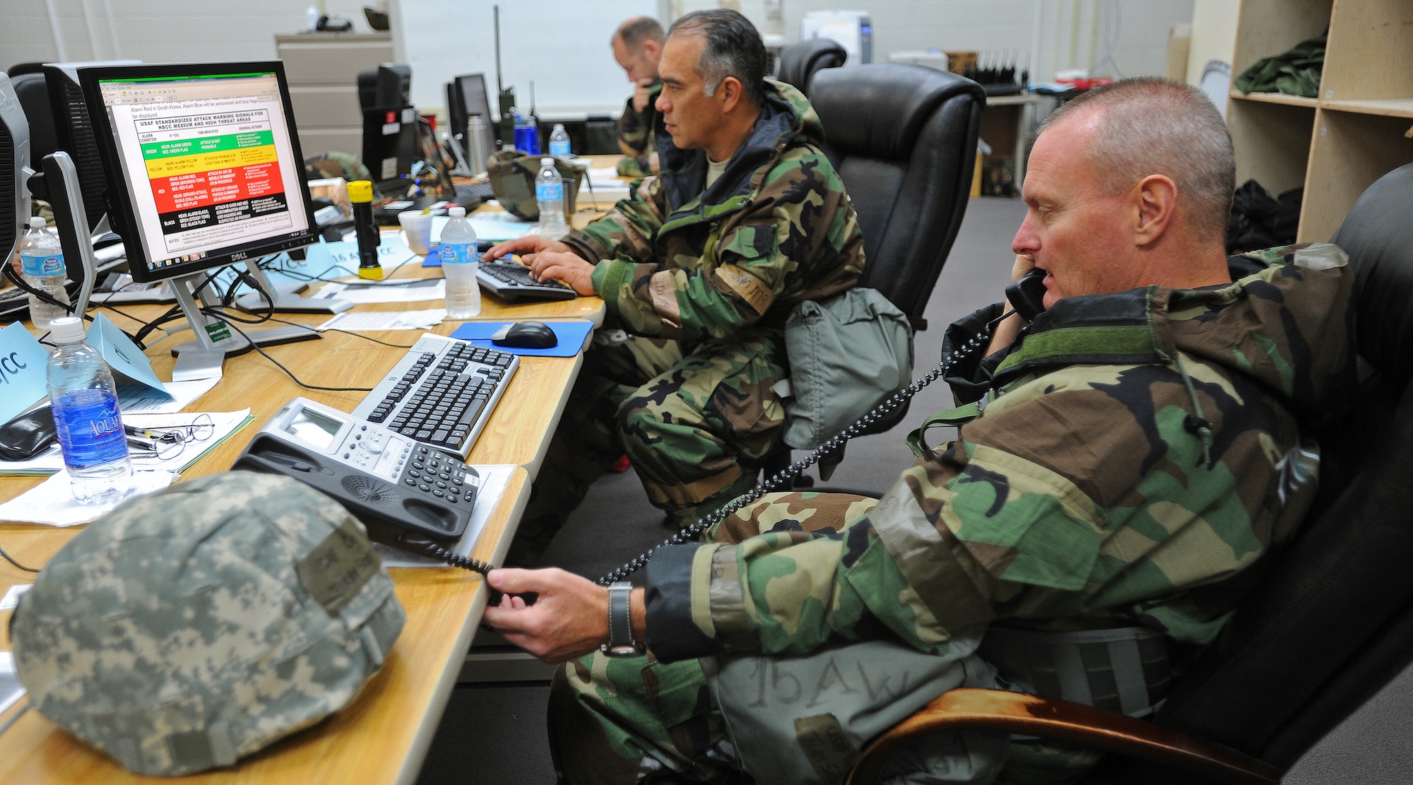 Col. Terry Scott, 15th Wing vice commander, right, and Brig. Gen. Braden Sakai, Hawaii Air National Guard 154th Wing commander, manage exercise postures  for assigned personnel at the Wing Operations Center, during an Operational Readiness exercise  at Joint Base Pearl Harbor-Hickam, Hawaii, Sept. 12, 2013. This exercise demonstrates the effective use of Total Force Integration by including both 15th Wing and 154th HIANG Airmen working side-by-side to accomplish the mission. (U.S. Air Force photo/Tech. Sgt. Jerome S. Tayborn)