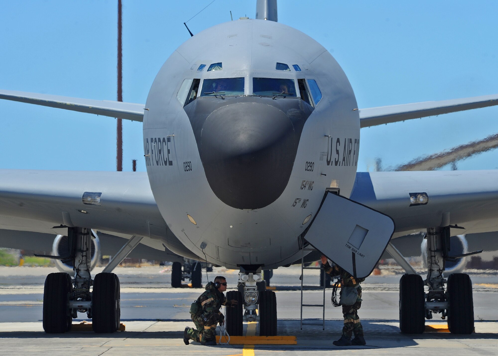 Airmen from the Hawaii Air National Guard 154th Aircraft Maintenance Squadron conduct preflight checks prior to launching a KC-135 Stratotanker on the flightline during an Operational Readiness Exercise at Joint Base Pearl Harbor-Hickam, Hawaii, Sept. 11, 2013. During the exercise, Airman had to don protective gear to protect against a simulated chemical attack, while still performing their normal maintenance duties on the KC-135 Stratotanker. (U.S. Air Force photo/Tech. Sgt. Jerome S. Tayborn)