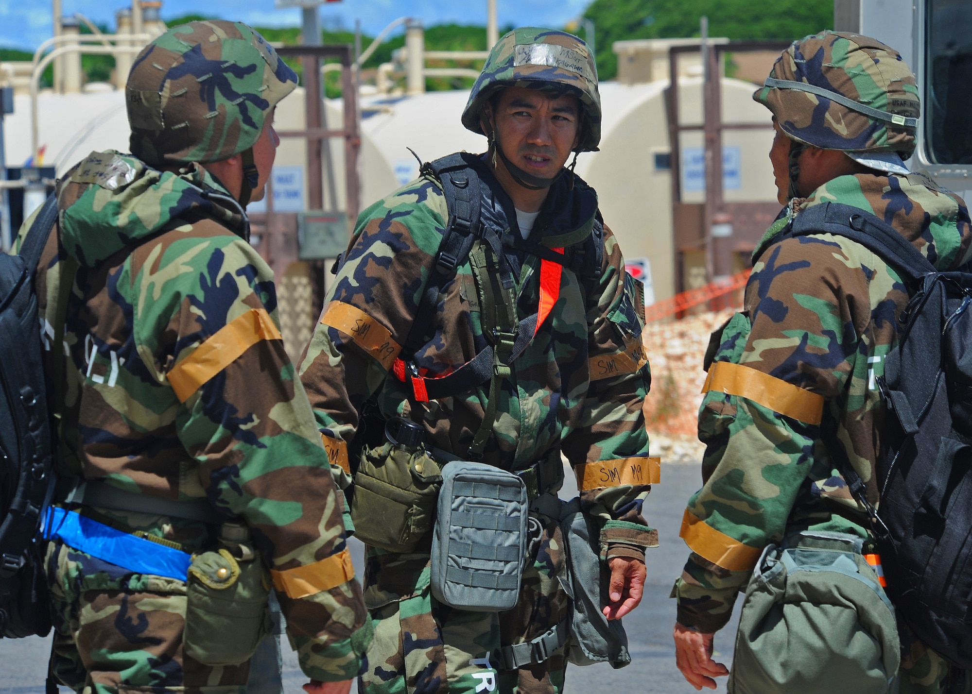 Members of the 15th Wing and the Hawaii Air National Guard 154th Wing discuss operation procedures near Hangar 17 during an Operational Readiness Exercise at Joint Base Pearl Harbor-Hickam, Hawaii, Sept. 11, 2013.  This exercise demonstrates the effective use of Total Force Integration by including both 15th Wing and 154th HIANG Airmen working side-by-side to accomplish a mission. (U.S. Air Force photo/Tech. Sgt. Jerome S. Tayborn)