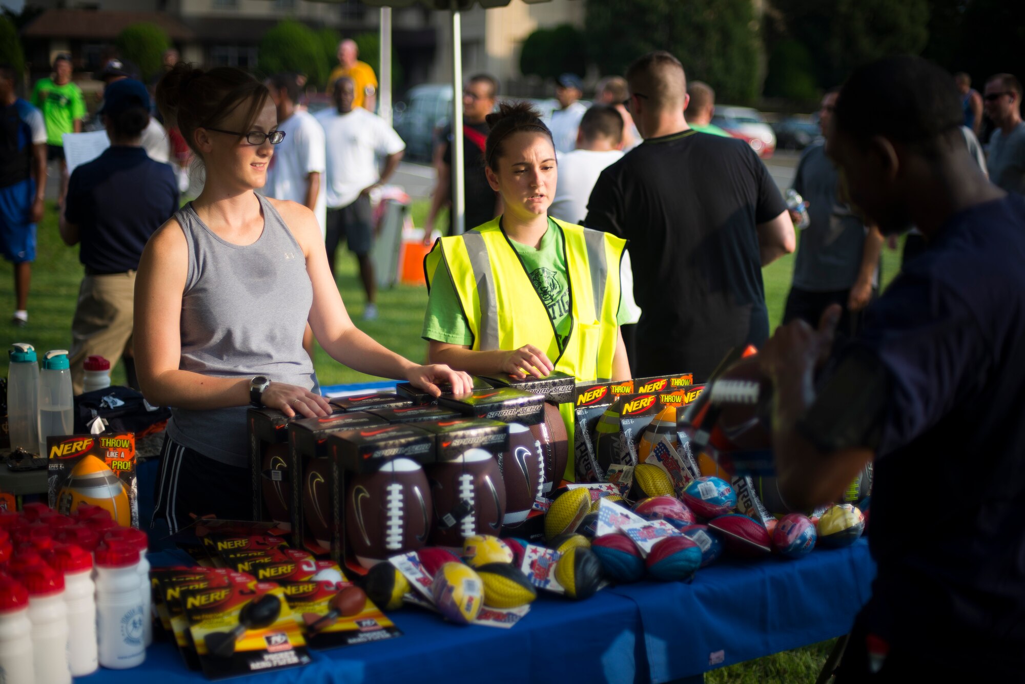 Volunteers hand out prizes after the Combined Federal Campaign 5K Fun Run Sept. 13, 2013 at Yokota Air Base, Japan. Prizes included footballs and water bottles. (U.S. Air Force photo by Staff Sgt. Chad C. Strohmeyer/released)