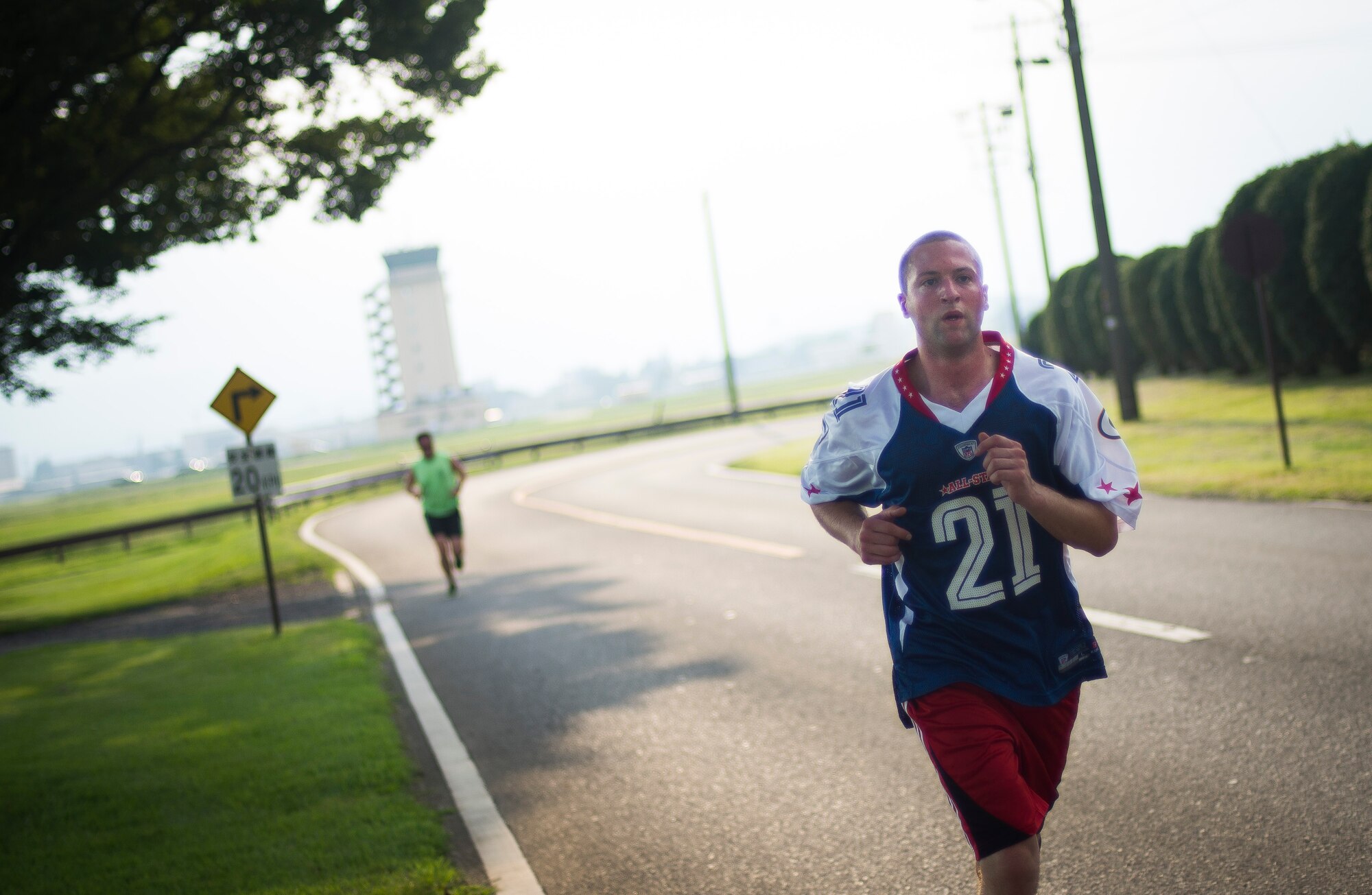 Airman 1st Class Trevor Sachs, 374th Operations Support Squadron air traffic controller, runs the last leg the Combined Federal Campaign 5K Fun Run Sept. 13, 2013 at Yokota Air Base, Japan. The volunteers were encouraged to wear their favorite football jersey while running. (U.S. Air Force photo by Staff Sgt. Chad C. Strohmeyer/released)