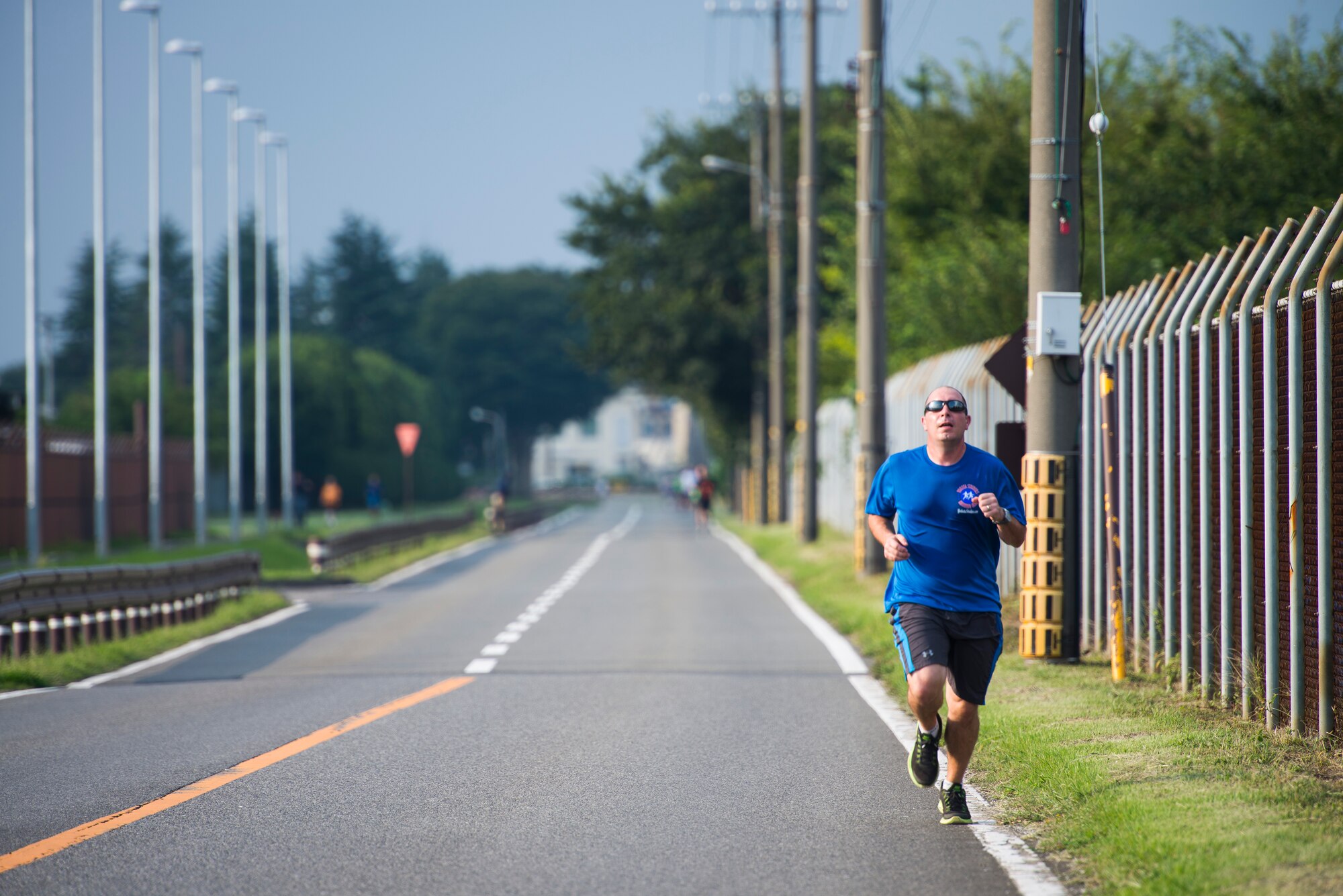 Beau Veazey, Yokota Middle School teacher, leads the pack during the Combined Federal Campaign 5K Fun Run Sept. 13, 2013 at Yokota Air Base, Japan. Veazey won the event with a time of 19:58. (U.S. Air Force photo by Staff Sgt. Chad C. Strohmeyer/released)