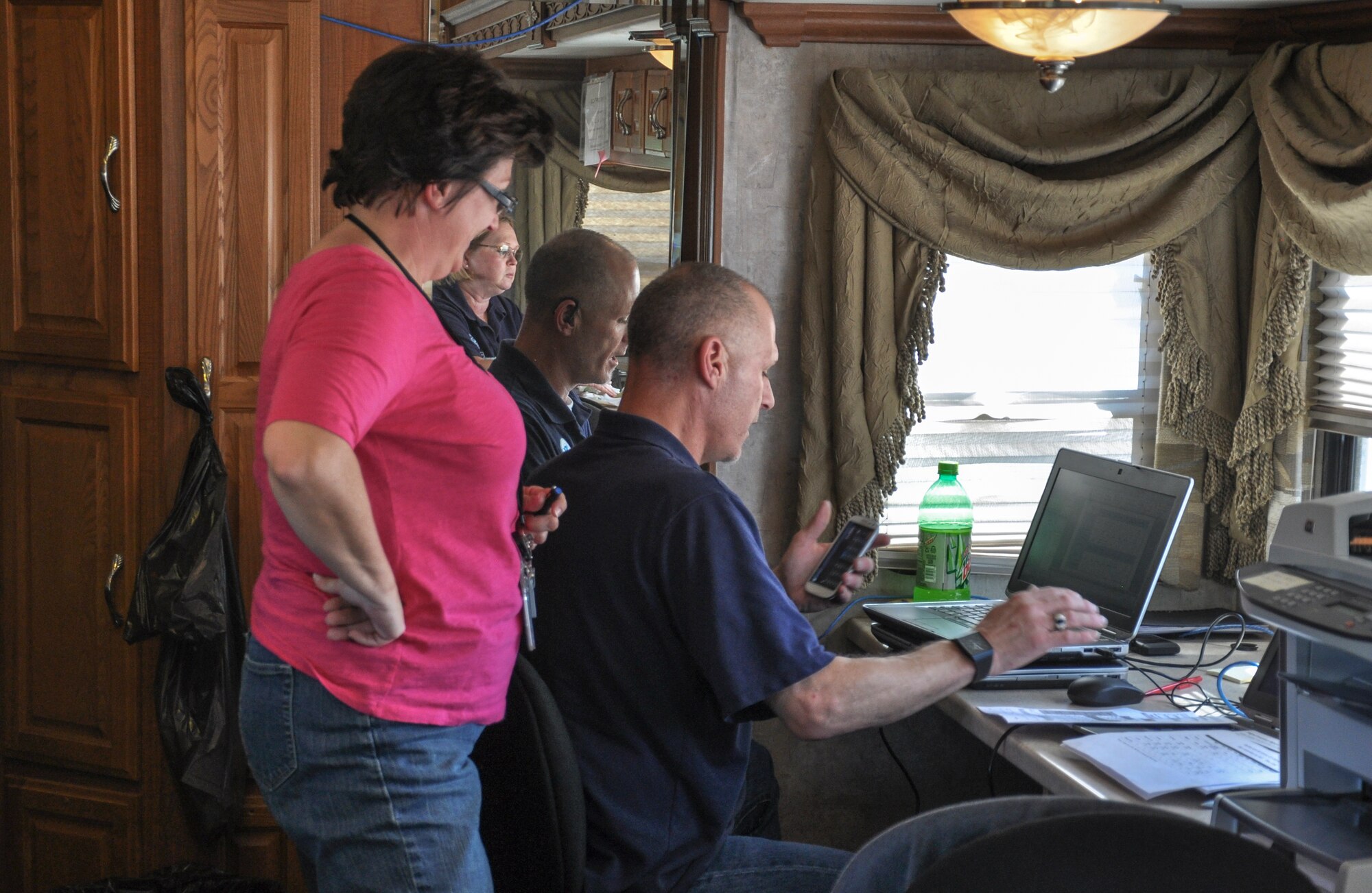 Federal Emergency Management Agency team members work inside the mobile command center Sept. 16, 2013, at Buckley Air Force Base, Colo. FEMA began staging operations out of Buckley Sept. 14, 2013, after Gov. John Hickenlooper declared a national emergency and President Barack Obama approved federal support. Major flood relief efforts became necessary after up to 15 inches of rain fell along the Front Range causing flash flooding, according to weather services. (U.S. Air Force photo by Staff Sgt. Nicholas Rau/Released)