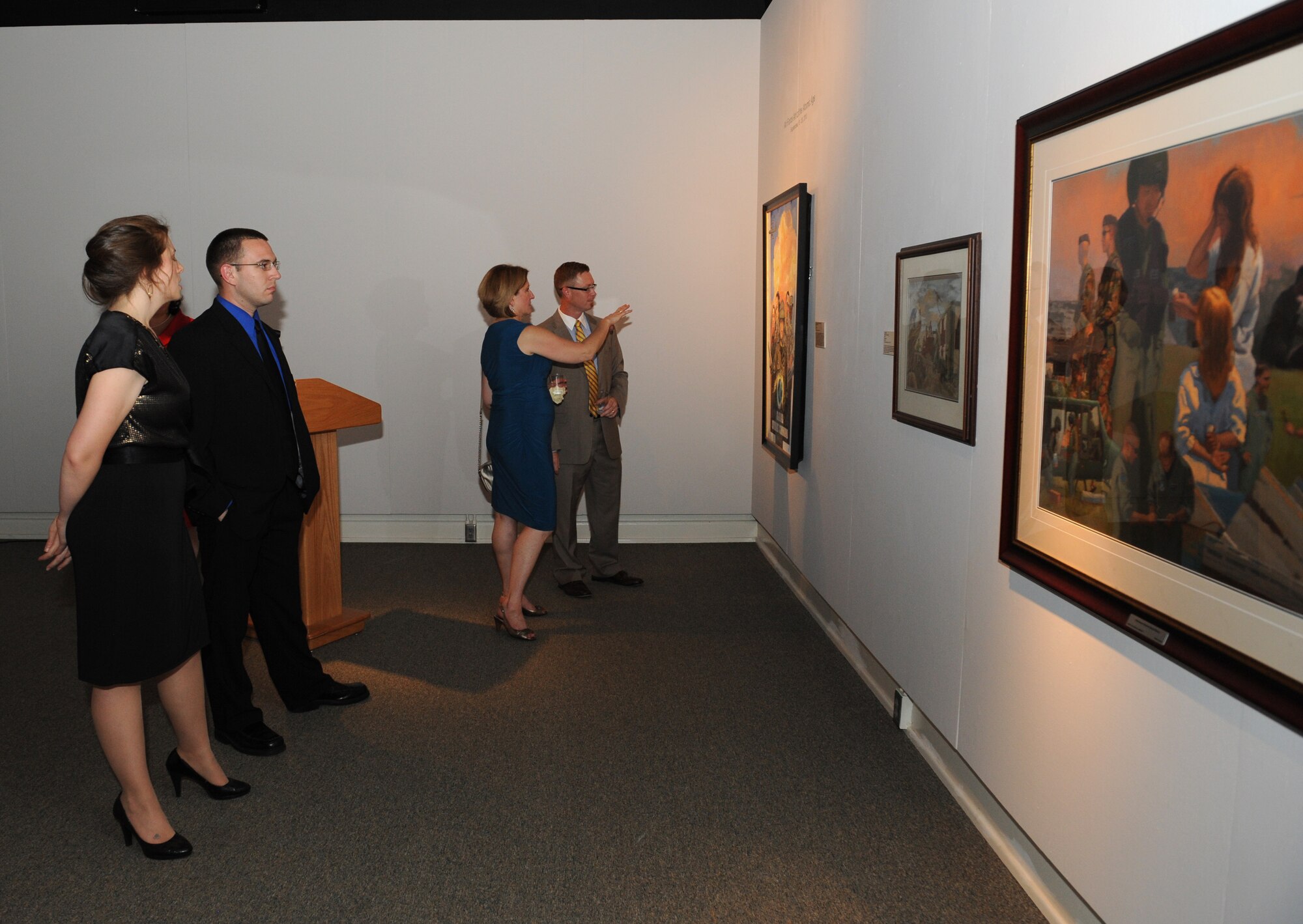 Attendees view artwork in the Air Force Art of the Atomic Age exhibit at the Meadows Museum of Art, at Centenary College of Louisiana, Shreveport, La., Sept. 12, 2013. The artwork portrays the experiences of its military members through paintings. (U.S. Air Force photo/Senior Airman Benjamin Gonsier)