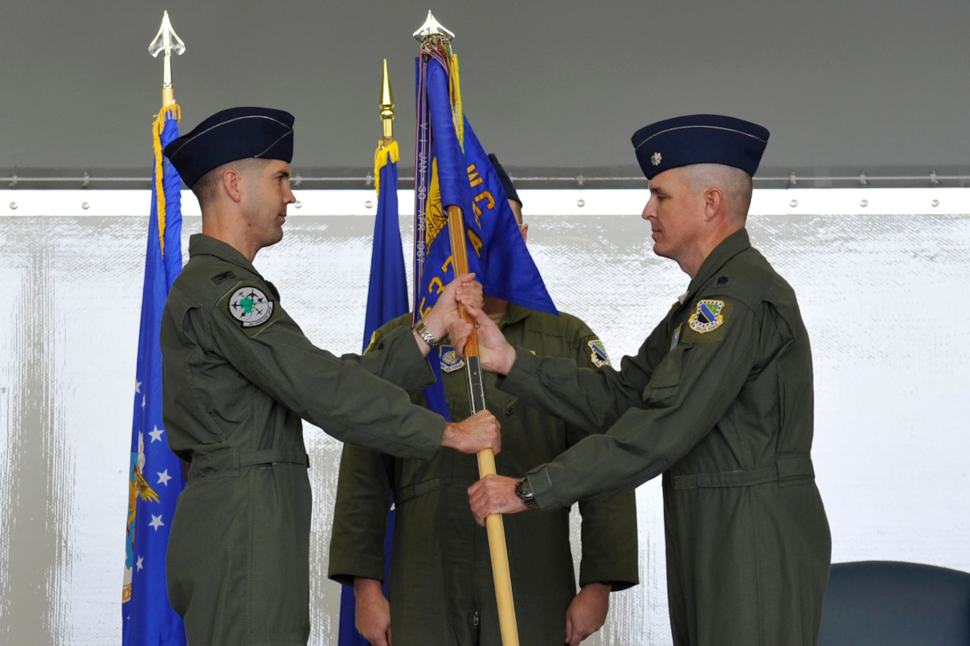 Air Force Col. Lansing Pilch, 3rd Operations Group commander, receives the 537th Airlift Squadron guidon from Air Force Lt. Col. Phillip Legg, 537th Airlift Squadron commander, during the 537th AS inactivation ceremony on JBER Wednesday. (U.S. Air Force photo/Airman 1st Class Tammie Ramsouer)