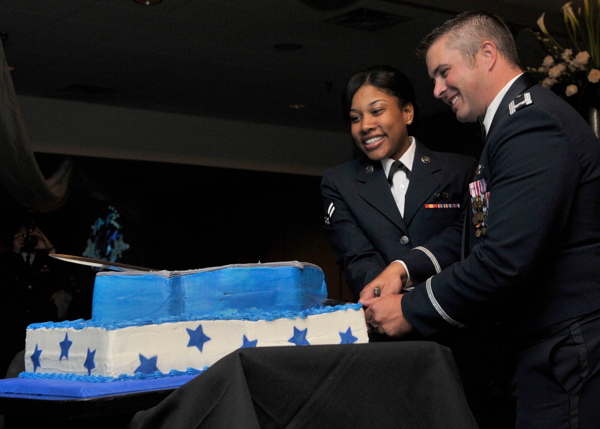 Airman 1st Class Cierra White, 325th Force Support Squadron career development journeyman, and Col. David E. Graff, 325th Fighter Wing commander, cut the cake during 2013 Annual Air Force Ball at Horizons Community Center, Sept. 14. (U.S. Air Force photo by Staff Sgt. Javier Cruz)