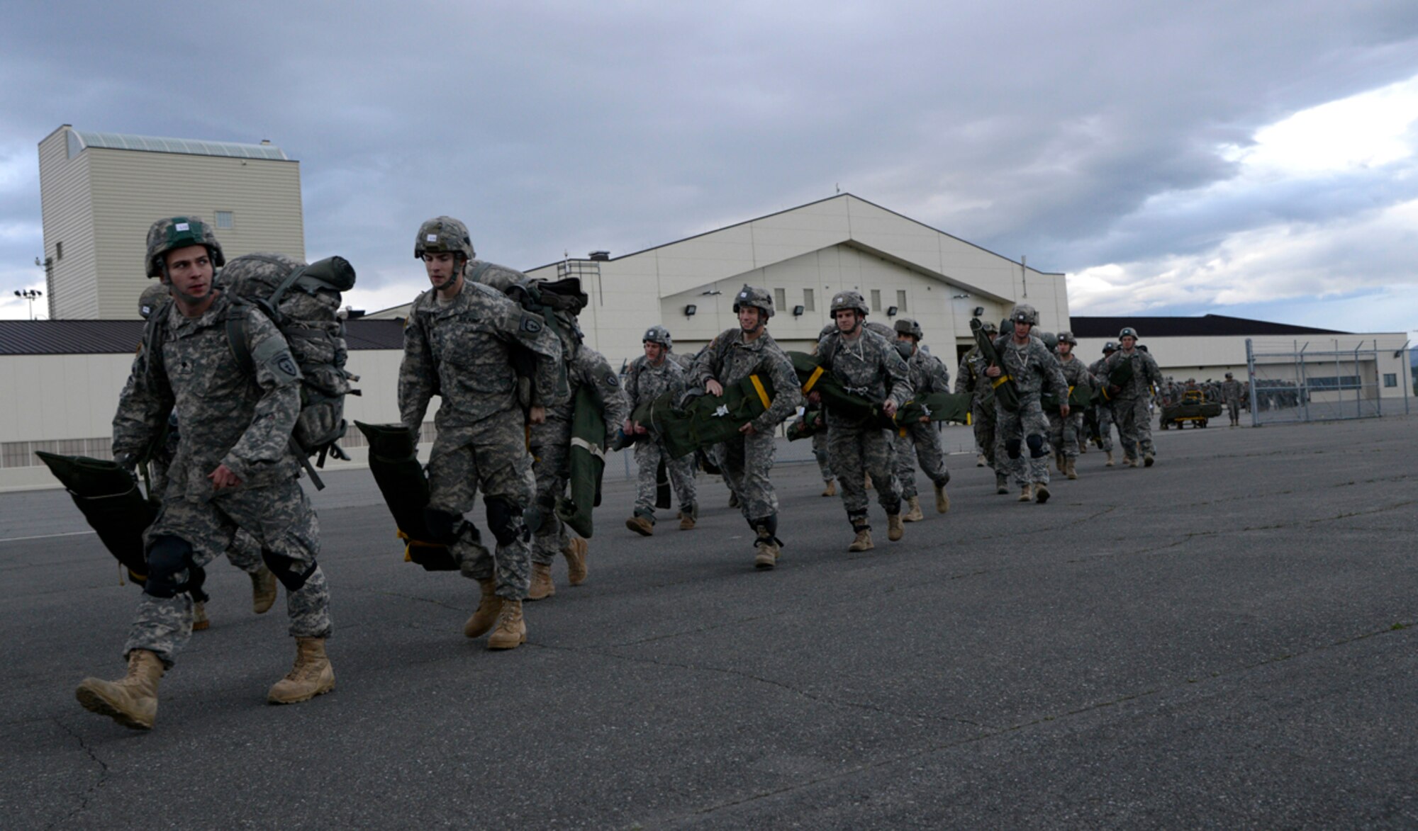 Paratroopers from the 4th Infantry Brigade Combat Team (Airborne) 25th Infantry Division prepares to board a C-17 Globemaster III at the Joint Mobility Center, Joint Base Elmendorf-Richardson, Alaska, Sept. 9, 2013. The brigade conducted an Emergency Deployment Readiness Exercise, a 48-hour drill that tests a unit's ability to prepare equipment and personnel required to respond to an emergency disaster. (U.S. Air Force photo/Staff Sgt. Sheila deVera/RELEASED)