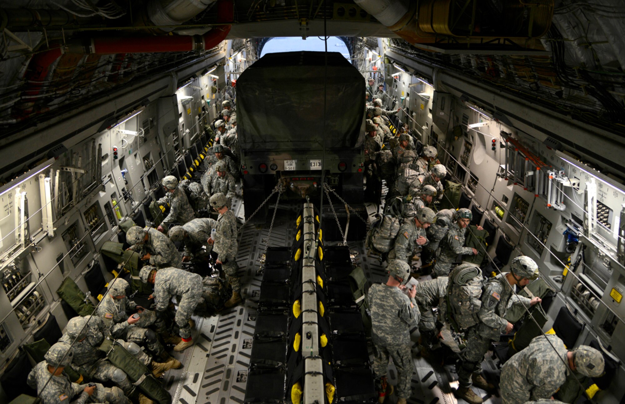 Paratroopers from the 4th Infantry Brigade Combat Team (Airborne) 25th Infantry Division prepares to board a C-17 Globemaster III at the Joint Mobility Center, Joint Base Elmendorf-Richardson, Alaska, Sept. 9, 2013. The brigade conducted an Emergency Deployment Readiness Exercise, a 48-hour drill that tests a unit's ability to prepare equipment and personnel required to respond to an emergency disaster. (U.S. Air Force photo/Staff Sgt. Sheila deVera/RELEASED)