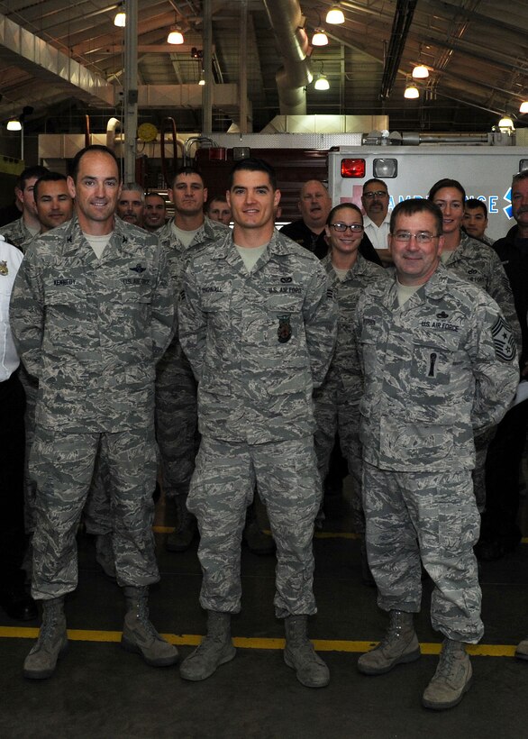Col. Kevin Kennedy, 28th Bomb Wing commander, and Chief Master Sgt. Kevin Peterson, 28th BW command chief, take a photo with Airmen from the Ellsworth fire department while on a visit to congratulate Senior Airman Zechariah Engwall (center) on receiving the 2012 Department of Defense Firefighter of the Year Award at Ellsworth Air Force Base, S.D., Sept. 11, 2013. Engwall, a 28th Civil Engineer Squadron vehicle operator, has been stationed at Ellsworth for almost three years. (U.S. Air Force photo by Airman 1st Class Rebecca Imwalle/Released)