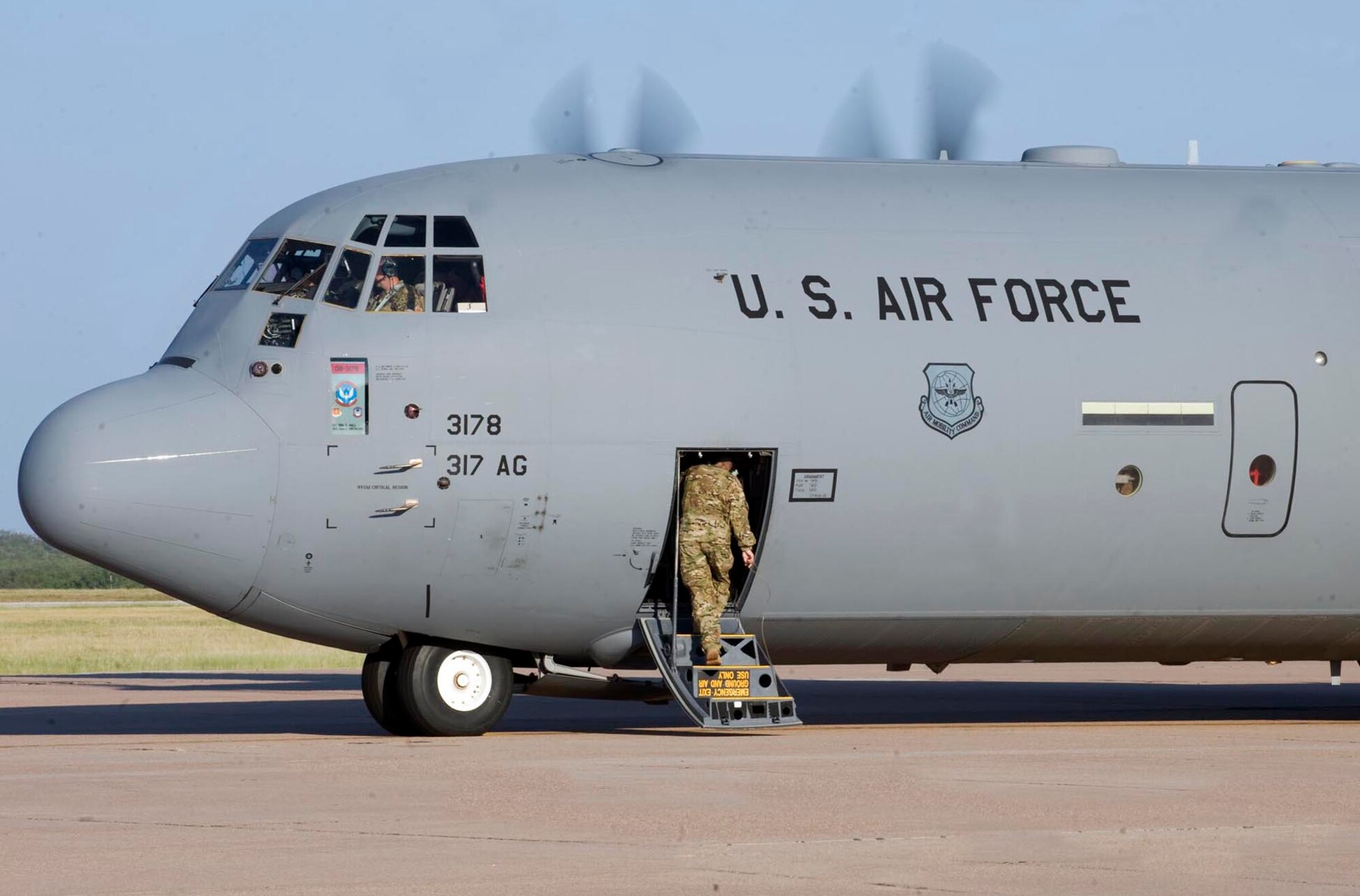 One last U.S. Air Force Airman boards a C-130 J-model before take-off Sept. 3, 2013, at Dyess Air Force Base, Texas. The 39th Airlift Group recently deployed in support of U.S. Central Command missions. While deployed, Airmen will support theater commander’s requirements with combat-delivery capability through tactical airland and airdrop operations as well as humanitarian efforts and aeromedical evacuation. (U.S. Air Force photo by Airman 1st Class Kylsee Wisseman)
