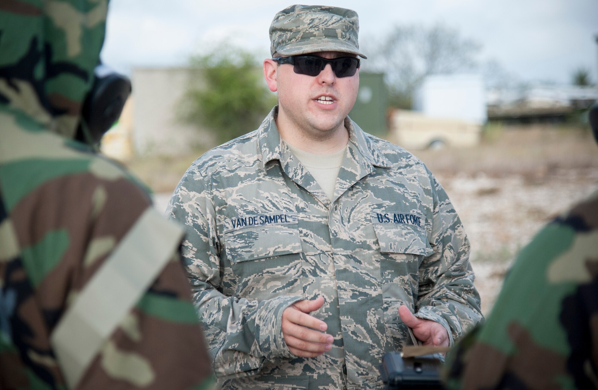 Staff Sgt. Theodore Van De Sample, 47th Civil Engineer Squadron readiness and emergency flight NCO in charge, briefs attendees of a chemical, biological, radiological and nuclear training course at Laughlin Air Force Base, Texas, Sept. 12, 2013. During the outside portion of the course, Van De Sample instructed students on several procedures to check for chemical exposure after an attack. (U.S. Air Force photo/Senior Airman John D. Partlow)
