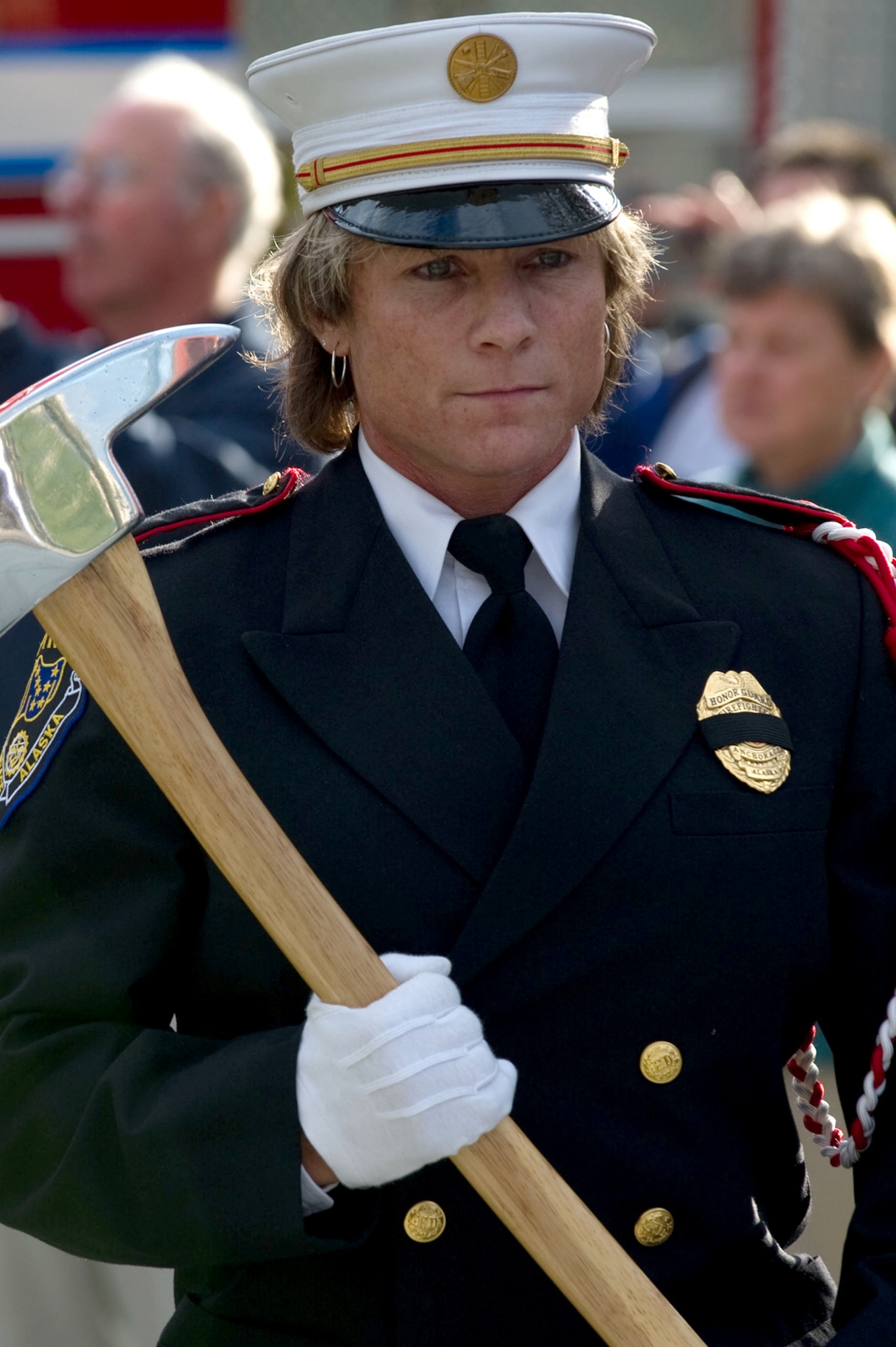 Heidi Hegg, a member of the International Association of Firefighters Local 1264, color guard, stands in formation during the playing of The National Anthem during the Alaska Fallen Firefighter Memorial Ceremony and 9/11 Remembrance Sept. 11, at the Alaska Fallen Firefighter Memorial. Participants wore black bands across their badges in remembrance of fallen comrades. (U.S. Air Force photo/Tech. Sgt. Raymond Mills)