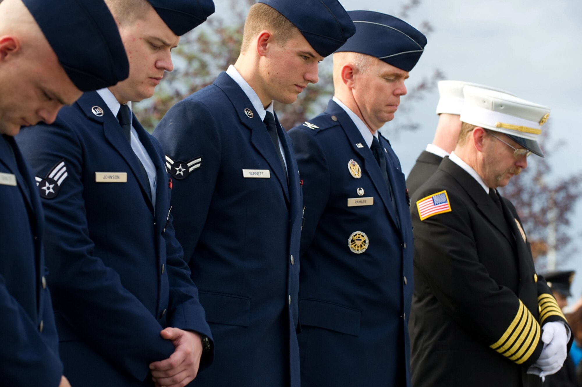 Airmen and firefighters observe a moment of silence during the Alaska Fallen Firefighter Memorial Ceremony and 9/11 Remembrance Sept. 11, at the Alaska Fallen Firefighter Memorial. (U.S. Air Force photo/Tech. Sgt. Chris Mills) 