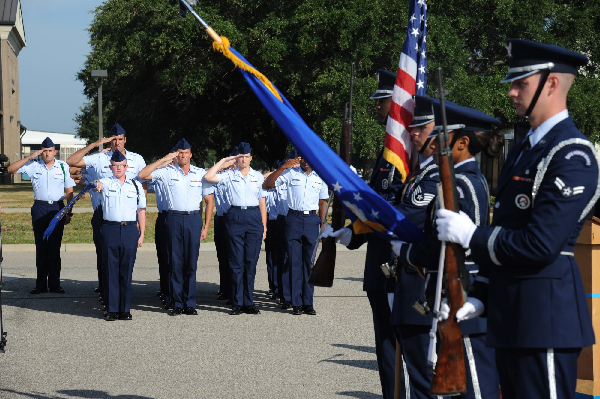 Students in the 338th Training Squadron render a salute as the Keesler Honor Guard presents the colors during a street dedication ceremony honoring a former technical training student, Chief Master Sgt. Richard Etchberger, Sept. 16, 2013, Keesler Air Force Base, Miss. Etchberger’s son, Cory Etchberger, assisted with the unveiling of a street sign and a memorial stone at the event.  (U.S. Air Force photo by Kemberly Groue)
