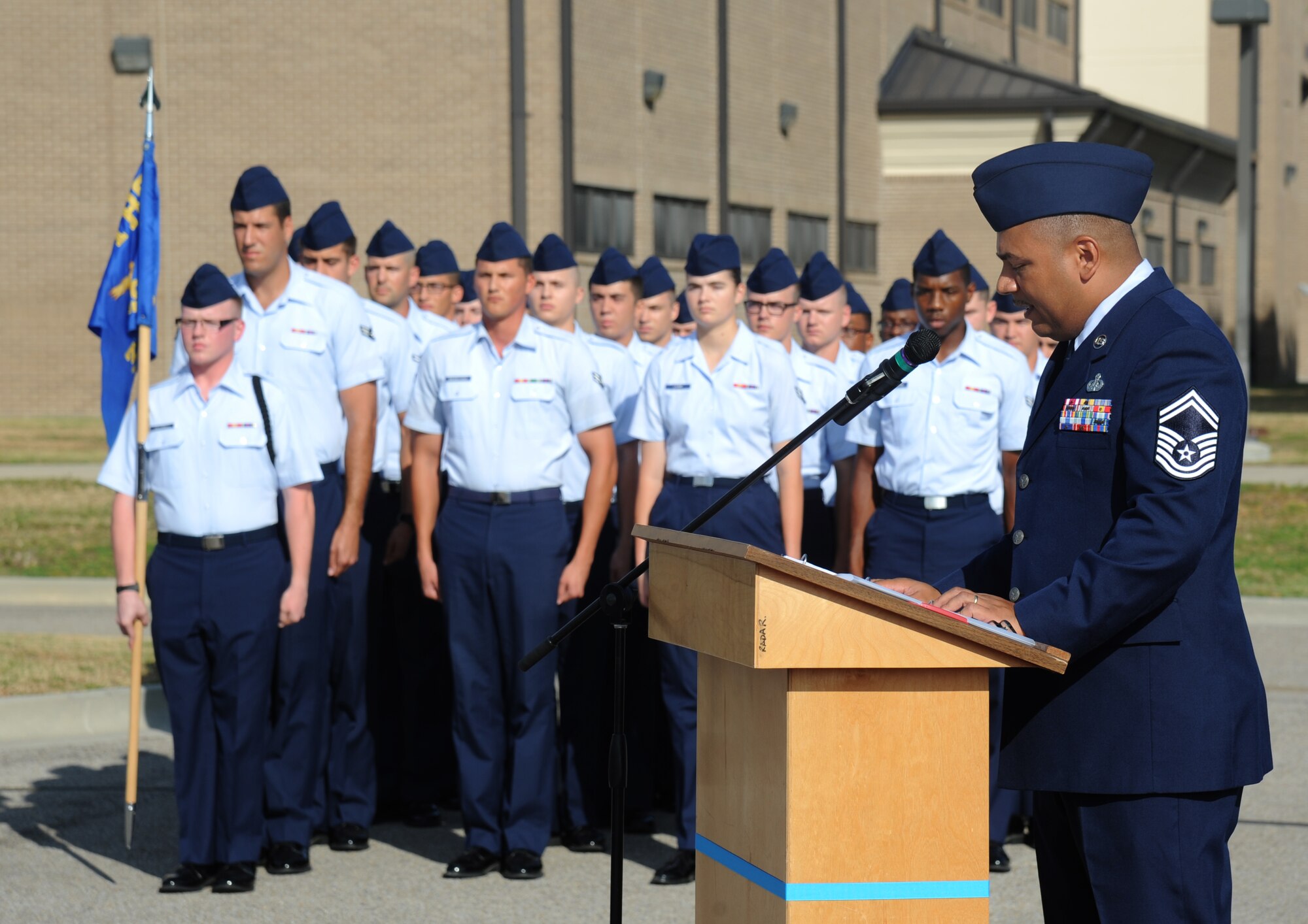 Students in the 338th Training Squadron stand in formation as Senior Master Sgt. Lorenzo Mendoza, 338th TRS, welcomes special guests to a street dedication ceremony honoring a former technical training student, Chief Master Sgt. Richard Etchberger, Sept. 16, 2013, Keesler Air Force Base, Miss. Etchberger posthumously received the Medal of Honor, the U.S. military’s highest decoration, in 2010. His son, Cory Etchberger, assisted with the unveiling of a street sign and a memorial stone at the event.  (U.S. Air Force photo by Kemberly Groue)