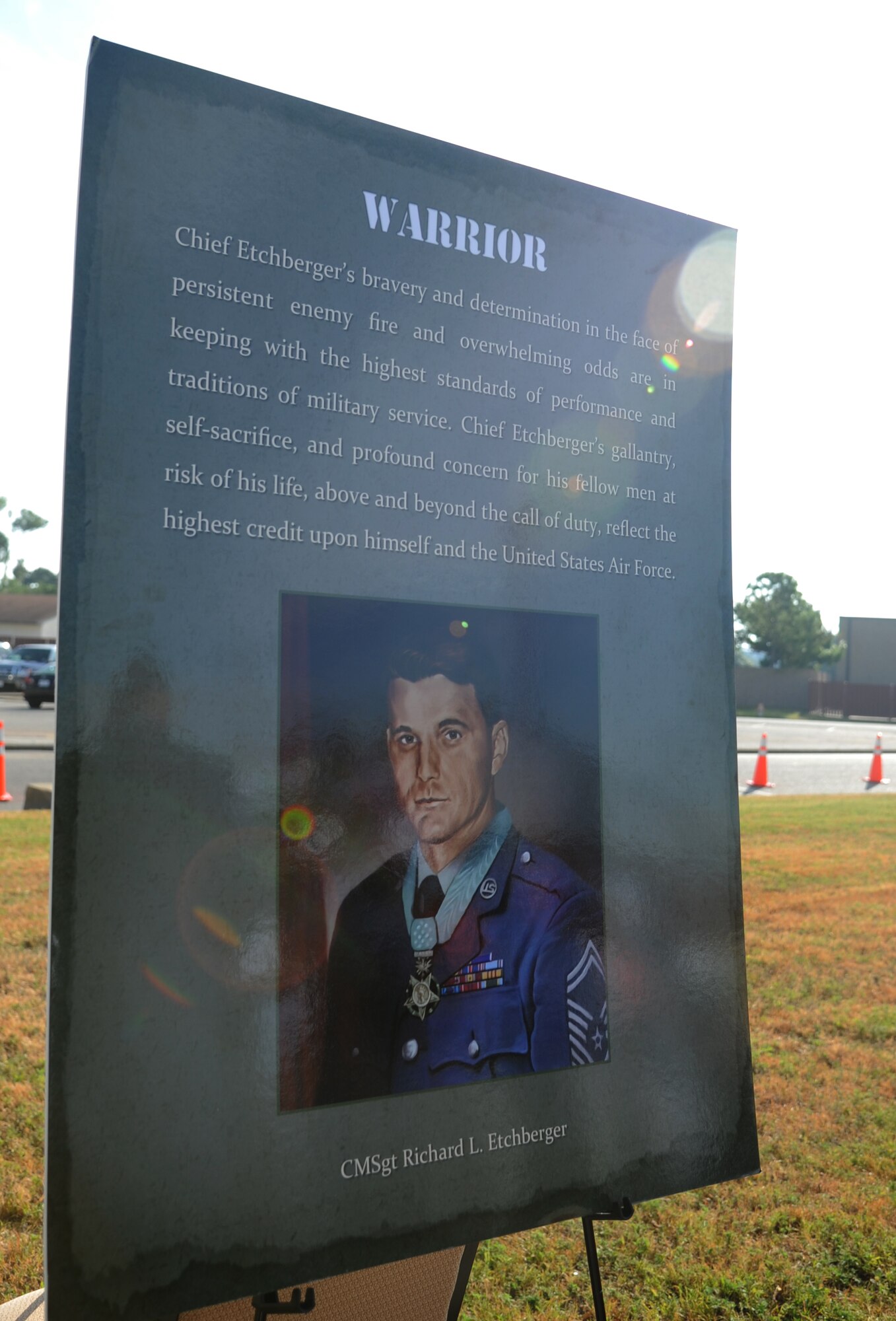 A poster is displayed during a street dedication ceremony honoring a former technical training student, Chief Master Sgt. Richard Etchberger, Sept. 16, 2013, Keesler Air Force Base, Miss. Etchberger posthumously received the Medal of Honor, the U.S. military’s highest decoration, in 2010. His son, Cory Etchberger, assisted with the unveiling of a street sign and a memorial stone at the event.  (U.S. Air Force photo by Kemberly Groue)