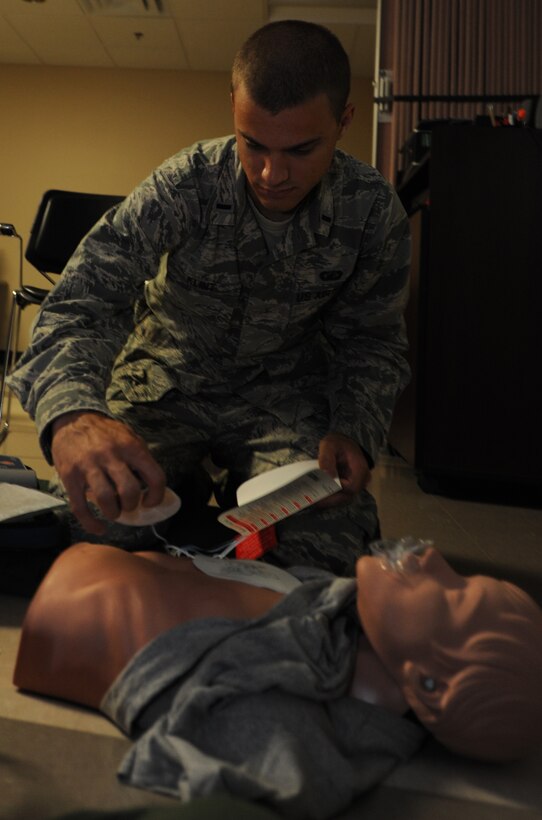 1st. Lt. Seth Klint, 28th Contracting Squadron officer in charge of the construction flight, places AED pads on a practice dummy during a CPR and AED class in the 28th Medical Group education and training room at Ellsworth Air Force Base, S.D., Sept. 11, 2013. The curriculum of the class included step-by-step instructions on how to operate a defibrillator, treat individuals who are choking and perform CPR. (U.S. Air Force photo by Airman 1st Class Hrair H. Palyan/Released)