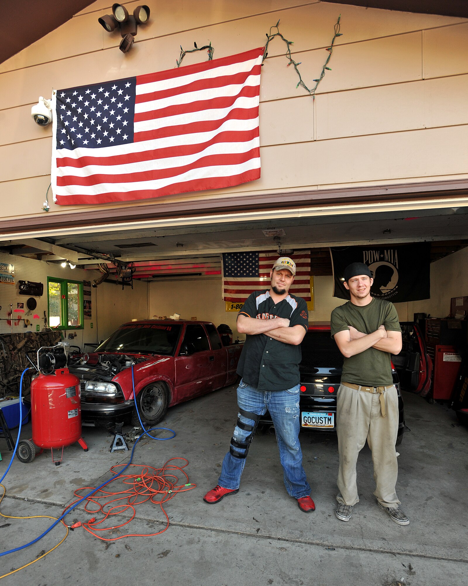 Larry Mendivil (left), president of Miracles for Vets and Marcos Frederick (right), vice president of Miracles for Vets, stand in front of the Miracles for Vets garage on Sept. 11, 2013, on Grand Forks, N.D. Miracles for Vets is a nonprofit organization which provides affordable vehicle repairs and vehicle modifications that can help with disabilities to disabled veterans and struggling families. (U.S. Air Force photo/Senior Airman Xavier Navarro)