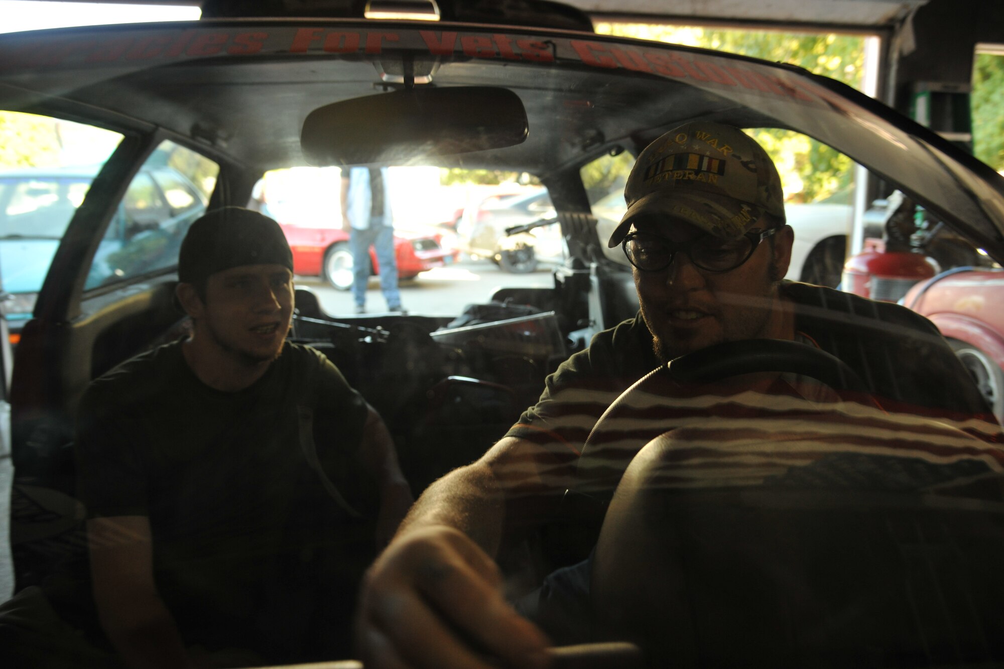 Larry Mendivil (right), president of Miracles for Vets, grabs a screw to put the steering wheel into place while Marcos Fredrick (left), vice president of Miracles for Vets watches him during the step by step process on Sept. 11, 2013, in Grand Forks, N.D. Miracles for Vets is a nonprofit organization which provides affordable vehicle repairs and vehicle modifications that can help with disabilities to disabled veterans and struggling families. (U.S. Air Force photo/Senior Airman Xavier Navarro)