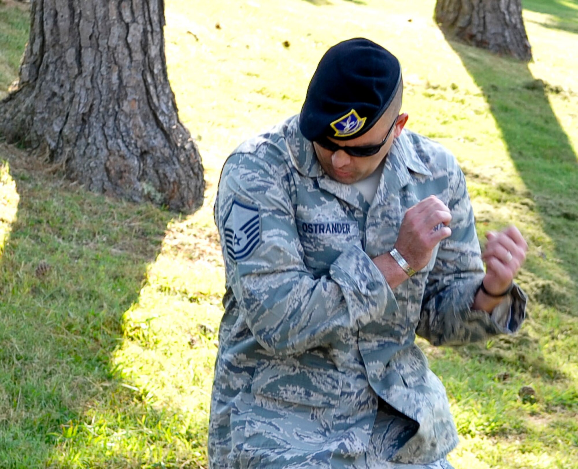 U.S. Air Force Master Sgt. Steven Ostrander, Air Combat Command security forces programs and requirements manager, reacts to a sudden heat wave produced by the Active Denial System at Fort Eustis, Va., Sept. 13, 2013. The ADS system allows personnel the capability to project a man-sized beam of millimeter waves at a range of up to 1,000 meters. (U.S. Air Force photo by Staff Sgt. Wesley Farnsworth/Released)
