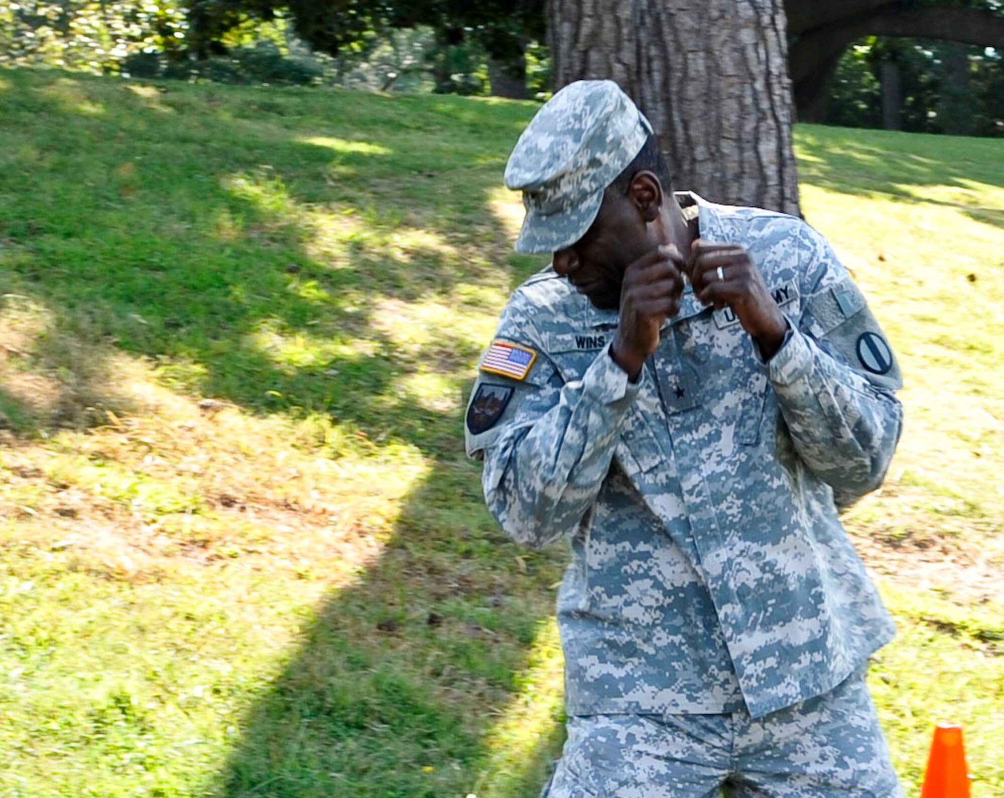 U.S. Army Brig. Gen. Cedric Wins, U.S. Army Training and Doctrine Command director of requirements and integration, reacts to a sudden heat wave produced by the Active Denial System at Fort Eustis, Va., Sept. 13, 2013. The ADS system penetrates the first one-sixtyfourth layer of the skin, which is where the individual’s nerve receptors reside. (U.S. Air Force photo by Staff Sgt. Wesley Farnsworth/Released)