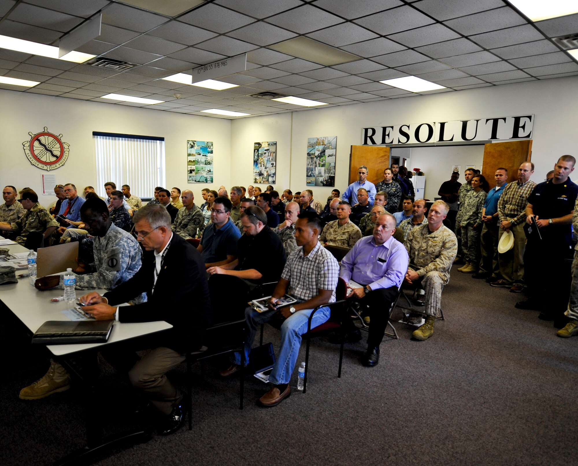 Service members, Department of Defense civilians and members of the House Armed Services Committee gather for a capabilities briefing of the Active Denial System at Fort Eustis, Va., Sept. 12, 2013. With more than 15 years of research and exposing 11,800 volunteers, the ADS system has demonstrated its effectiveness and the ability to use it with minimal risk of injury. (U.S. Air Force photo by Staff Sgt. Wesley Farnsworth/Released)