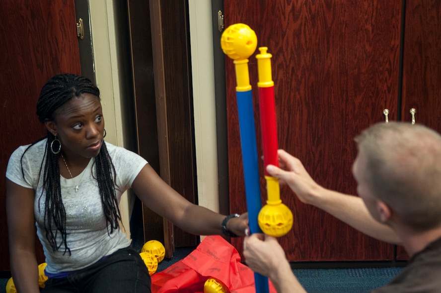 U.S. Air Force Staff Sgt. Erica Mitchell, 23d Wing Chapel chaplain assistant, and Staff Sgt. Ryan Erwin, 23d Wing Chapel NCO in charge of education and training, construct a maze during a workplace communication class at Moody Air Force Base, Ga., Sept. 9, 2013. This team-building portion of the class is meant to strengthen communication skills and teamwork. (U.S. Air Force photo by Airman 1st Class Sandra Marrero/Released)
