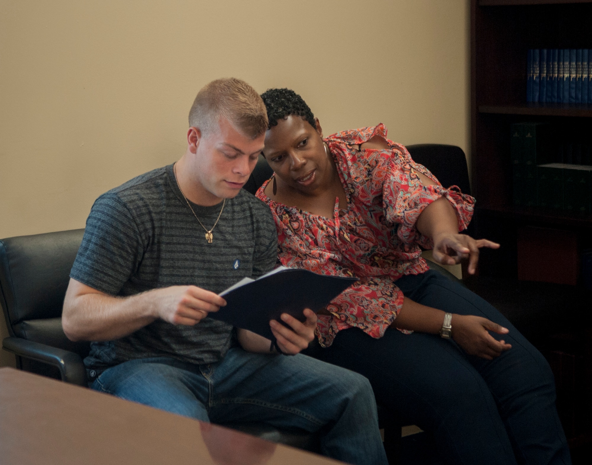 Lawanna Barron, Family Advocacy outreach manager, and U.S. Air Force Senior Airman Jordan Sager, 23d Medical Group mental health technician, observe group dynamics of Airmen during a workplace communication class at Moody Air Force Base, Ga., Sept. 9, 2013. Afterward, the pair gave feedback about the group’s teamwork and how it related to their workplace interactions. (U.S. Air Force photo by Airman 1st Class Sandra Marrero/Released)
