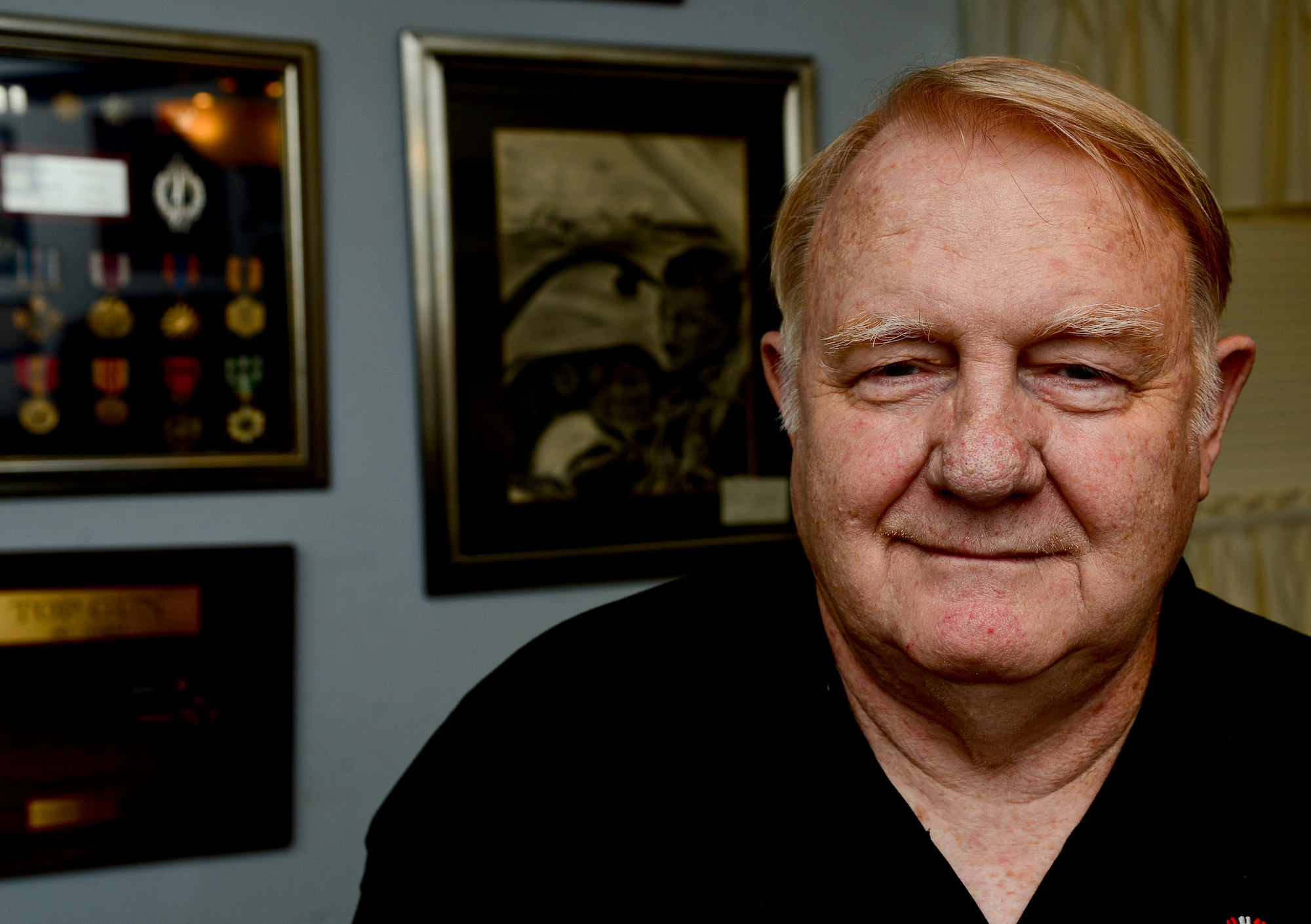 Retired U.S. Air Force Col. William E. Townsley stands in front of his memorabilia wall at his home in Yorktown, Va., Sept. 12, 2013. Townsley was a second lieutenant when he was shot down and rescued in Vietnam. (U.S. Air Force photo by Senior Airman Kayla Newman/Released)