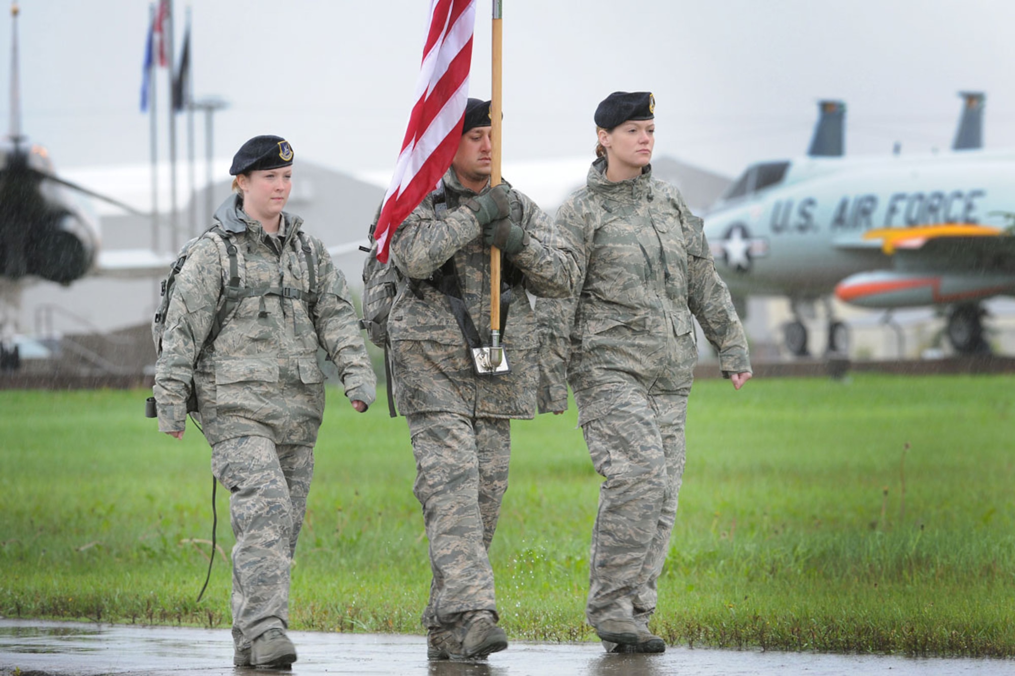 Investigator Qualle (left), Investigator Belt (center) and Investigator Brown, all of the 673d Security Forces Squadron, carry the flag near Heritage Park on JBER Wednesday. Squadron personnel marched for 24 hours in memory of Air Force Staff Sgt. Todd Labraico Jr., who died of wounds received by small arms fire Sept. 5 while deployed to Bagram Airfield, Afghanistan with the 105th SFS. (U.S. Air Force photo/Justin Connaher) 
