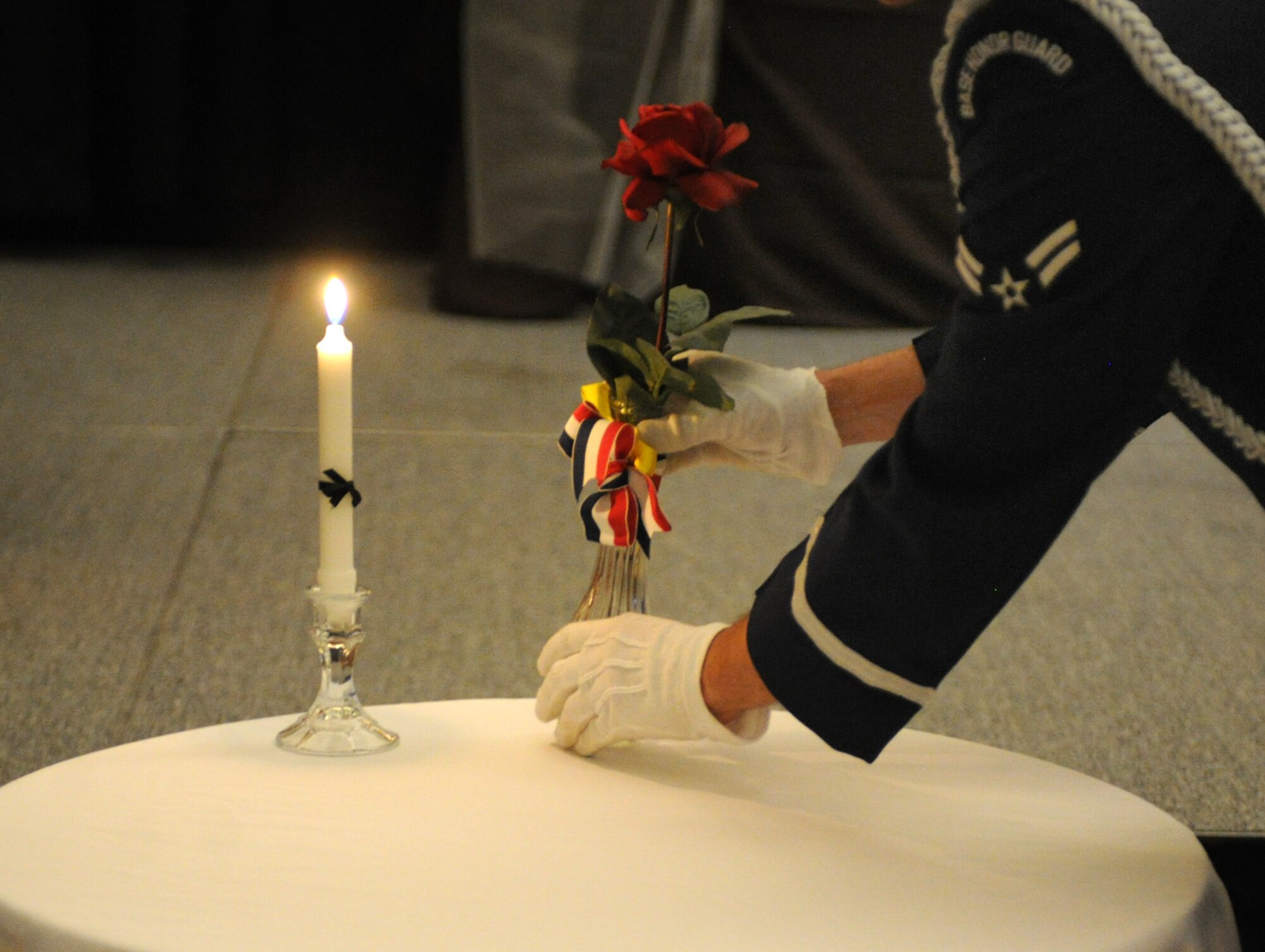 A member of base honor guard preforms a Prisoner of War/Missing in Action tribute Sept. 14, 2013 at the Air Force Ball held at the Clovis Civic Center in Clovis, N.M. The Air Force Ball is an annual celebration held in honor of the day the Air Force became a separate branch of service. (U.S. Air Force photo/Senior Airman Ericka Engblom)