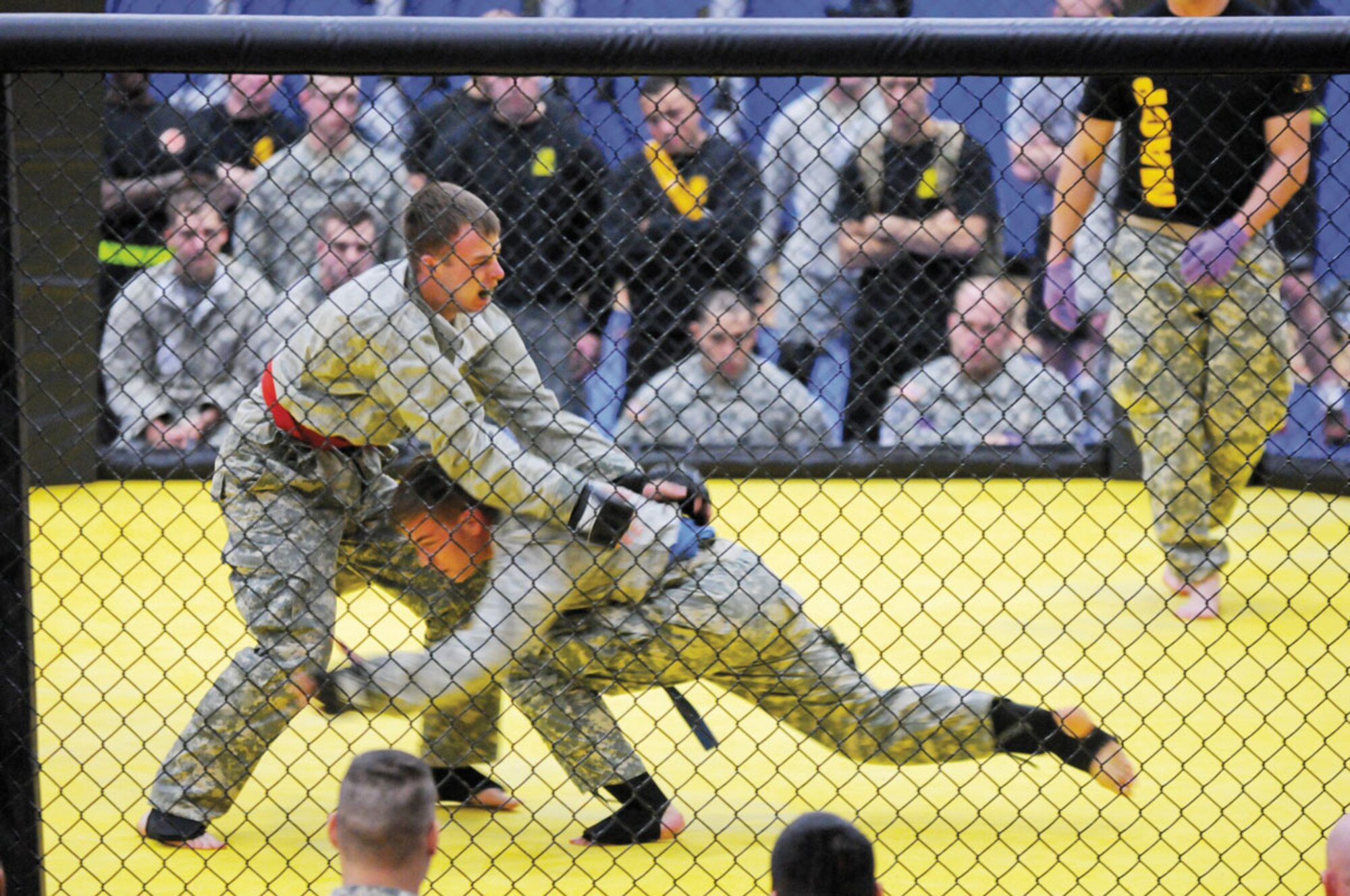 Paratroopers with the 4th Infantry Brigade Combat Team (Airborne), 25th Infantry Division, compete for top honors in the Army combatives competition as part of Sparta Week Sep. 5. Troops and families spent the week in friendly competition, building esprit de corps during the events. (U.S. Army photo by Staff Sgt. Jeffrey Smith/released)