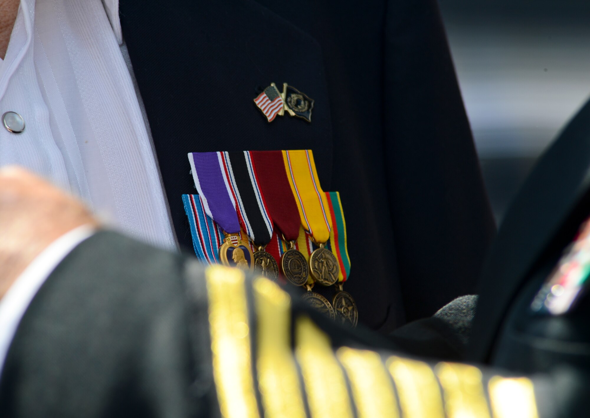 Petty Officer 2nd Class McPherson Plecker, a World War II veteran and prisoner-of-war, receives his nine military decorations during a tribute honoring him at The Palms of Largo in Largo, Fla., on Sept. 14, 2013. During WWII, Plecker defended Wake Island and endured four years as a POW in Japanese and Chinese war camps. (U.S. Air Force photo by Senior Airman Shandresha Mitchell/Released)