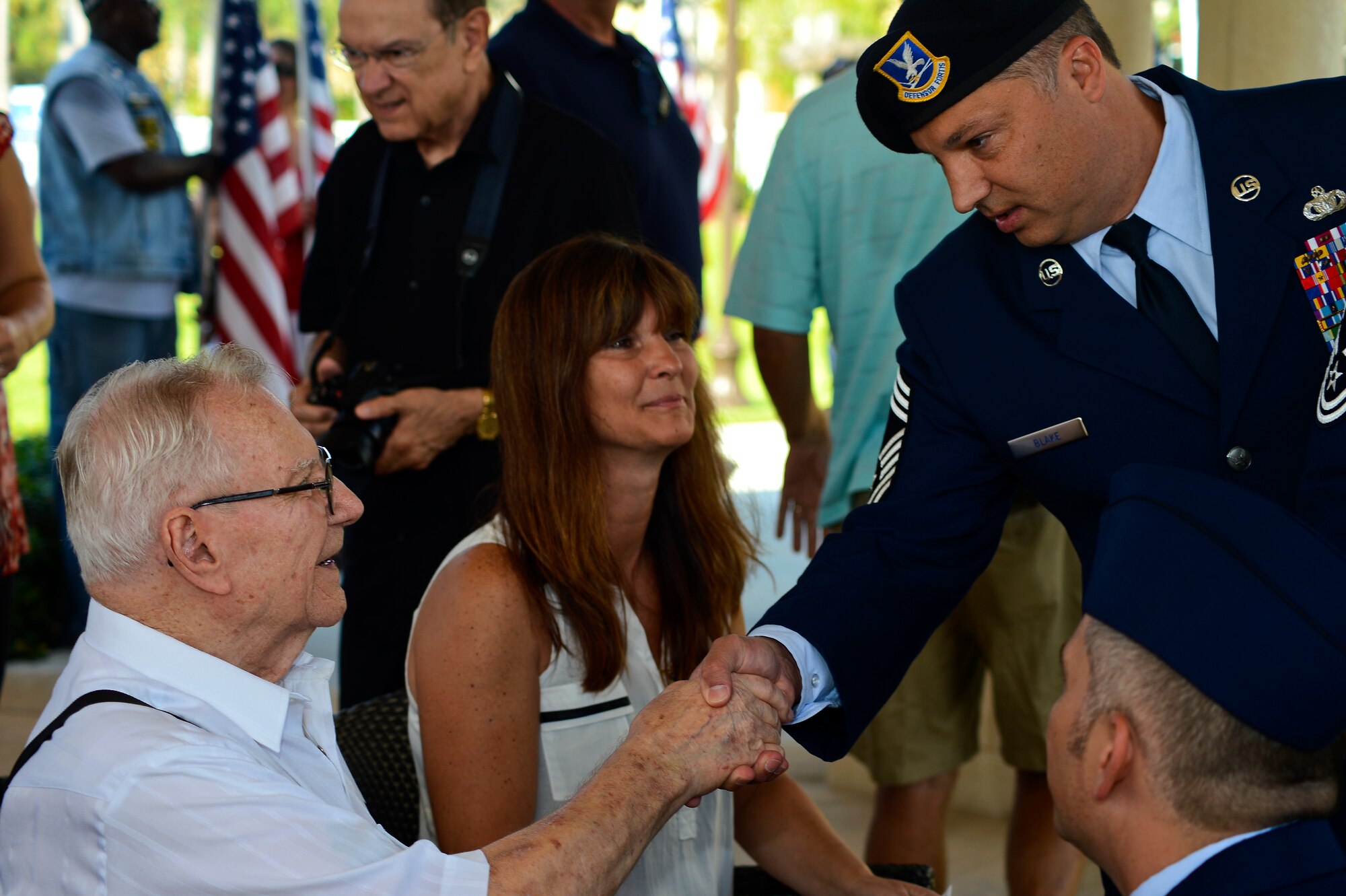 Chief Master Sgt. Timothy Blake, 6th Security Forces manager, shakes Petty Officer 2nd Class McPherson Plecker, a World War II veteran and prisoner-of-war, hand during a tribute honoring him at The Palms of Largo in Largo, Fla., on Sept. 14, 2013. Several of MacDill Air Force Base senior leaders attended the ceremony honoring Plecker. (U.S. Air Force photo by Senior Airman Shandresha Mitchell/Released)