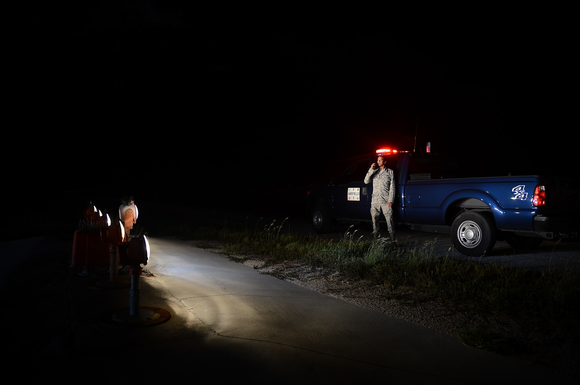 Senior Airman Benjamin Stewart, 6th Operations Squadron airfield management coordinator, inspects the runway approach lighting at MacDill Air Force Base, Fla., Sept. 12, 2013. The purpose of the runway approach lighting is to provide pilots visual guidance to the utilizable surface on the runway at night and during periods of inclement weather. (U.S. Air Force photo by Senior Airman Melanie Bulow-Kelly/Released)