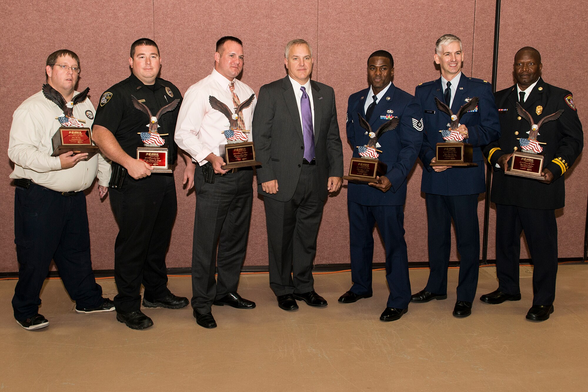 U.S. Air Force Tech. Sgt. Keyne Moseley (third from the right), stands with other recipients of the Patriot Award following a ceremony held in Bossier City, La., Sept. 11, 2013. The annual Patriot Awards Banquet honors Bossier Parish military personnel, law enforcement, firefighters and emergency medical first responders. (U.S. Air Force photo by Master Sgt. Greg Steele/Released)