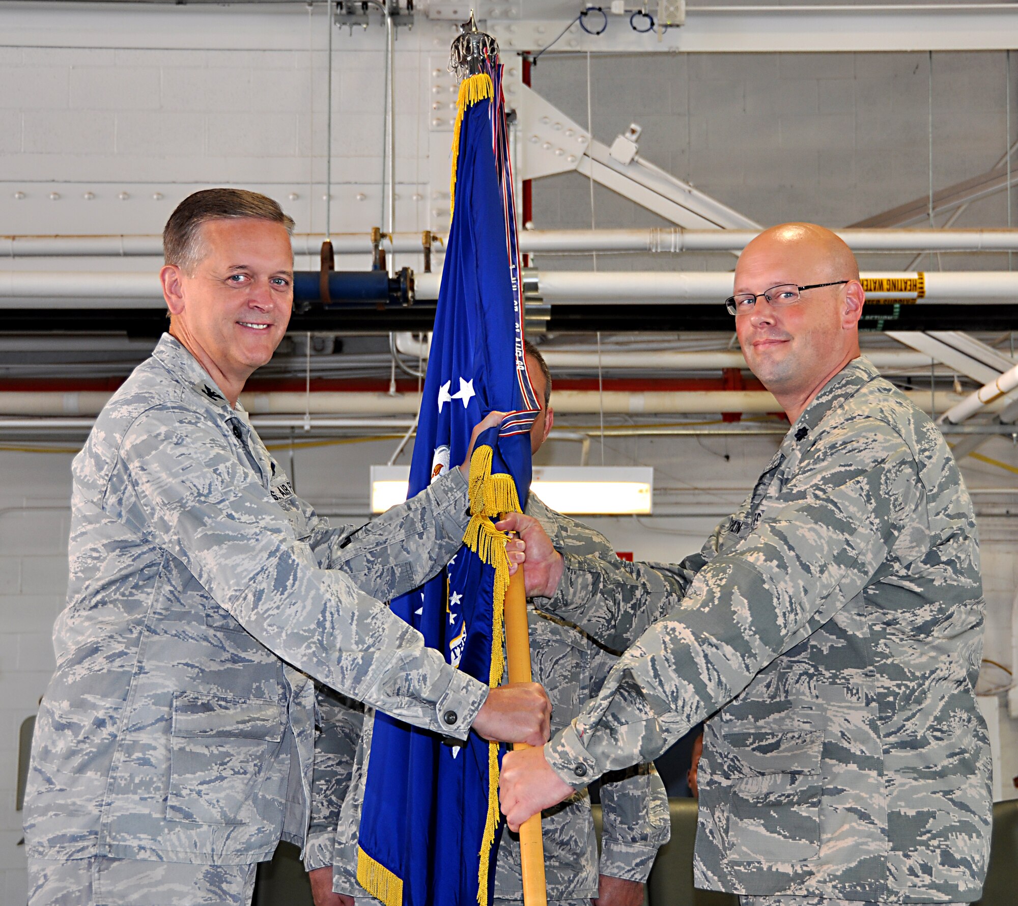Lieutenant Colonel Travis Caughlin, right, accepts command from Col. Russell Muncy, 507th Air Refueling Wing commander during a change of command ceremony held here September 8, 2013.  Caughlin comes to the 507th Maintenance Group after serving as deputy commander for maintenance, 917th Fighter Group, Barksdale AFB La.  (U.S. Air Force photo/Senior Airman Mark Hybers)