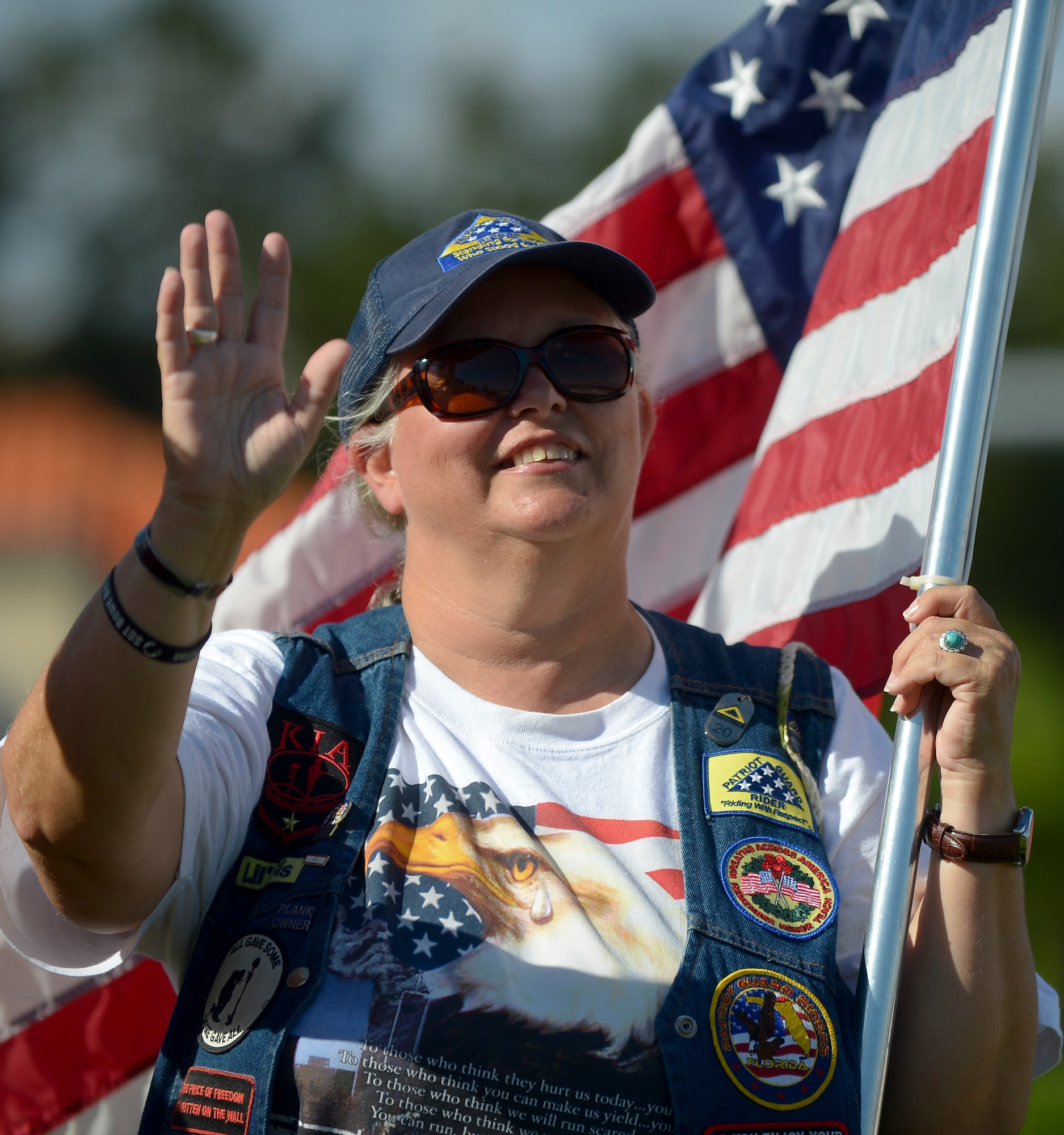 Carol Radlein, Bayshore Patriots member, smiles and waves to passers-by Sept. 11, 2013 in Tampa, Fla in honor of the 12th anniversary of 9/11. The Bayshore Patriots are a group of  former military members, parents of military members, and those simply wishing to show their patriotism. (U.S. Air Force photo by Senior Airman Melissa Paradise/Released)