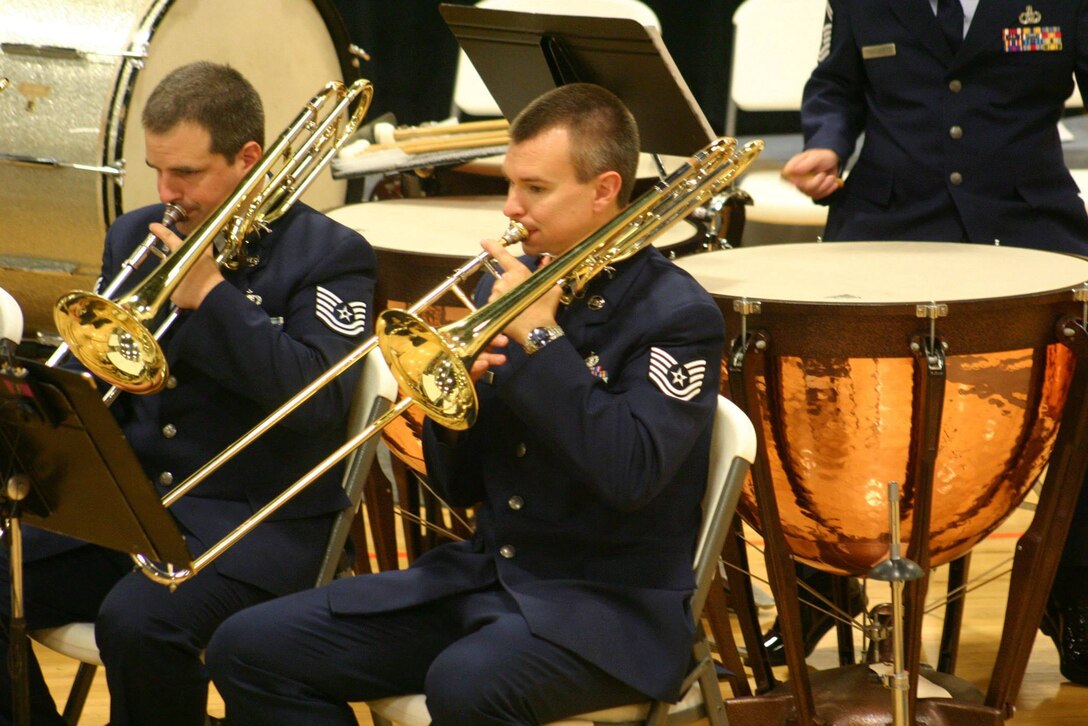 TSGT David Fairchild and TSGT Daniel Stone play trombone in the Concert Band during a concert in Oneida, TN on June 23, 2013