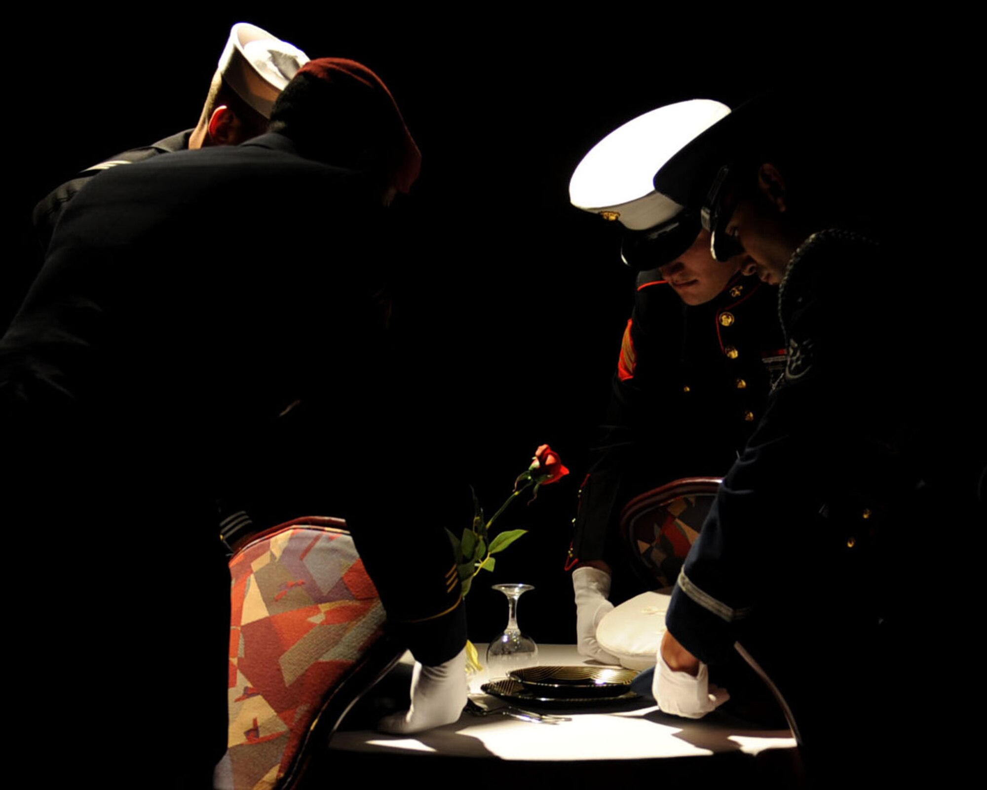 Representatives from the U.S. Army, U.S. Navy, U.S. Marine Corps, and U.S. Air Force pay their respects to the Prisoner of War/Missing in Action table Sept. 14, 2013, the Galaxy Club Sept. 14, 2013, during the Air Force Ball on RAF Mildenhall, England. The table was set in remembrance of the men and women of the United States who sacrificed their freedom in the defense of their country. (U.S. Air Force photo by Airman 1st Class Preston Webb/Released)
 
