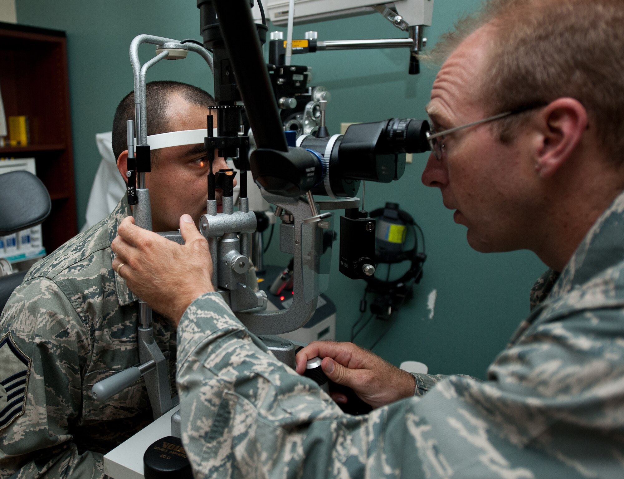 Maj. Bryan Kemper, 28th Medical Operations Squadron optometrist, uses a slit-lamp to view the eyes of Master Sgt. Juan Lopez, 28th Aircraft Maintenance Squadron production superintendent, during an eye exam at Ellsworth Air Force Base, S.D., Sept. 12, 2013. Optometrists use bio-microscopes to determine the health of the front and back surfaces of a patient’s eye. (U.S. Air Force photo by Airman 1st Class Alystria Maurer/Released)