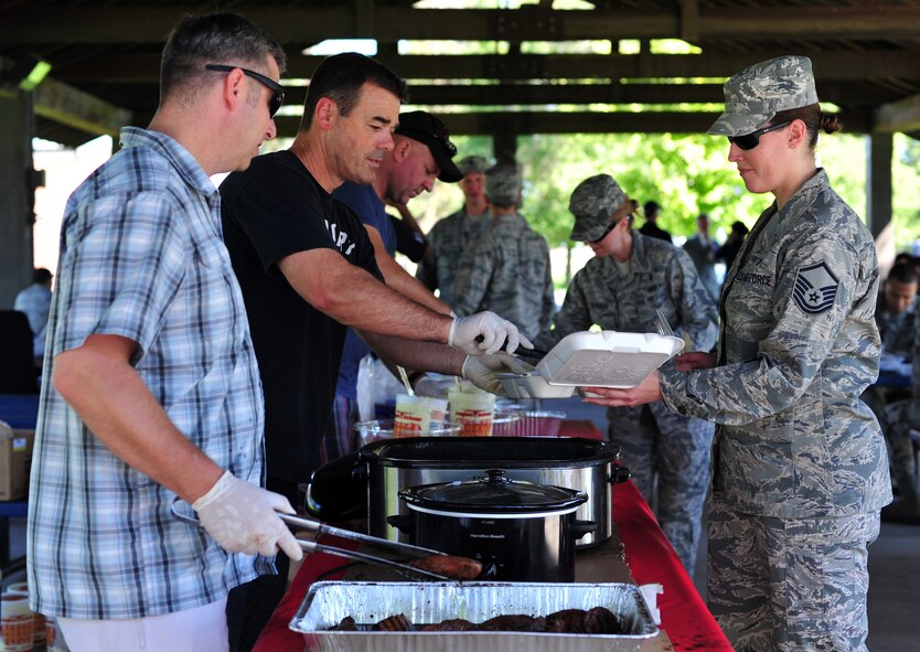 Members of Team Fairchild are served steak during the Chief Steak Out event at Miller Park, Fairchild Air Force Base, Wash., Sept. 13, 2013. The cookout is an annual event when all the chiefs on base get together and prepare steaks for members of Team Fairchild. (U.S. Air Force photo by Senior Airman Taylor Curry/ Released)