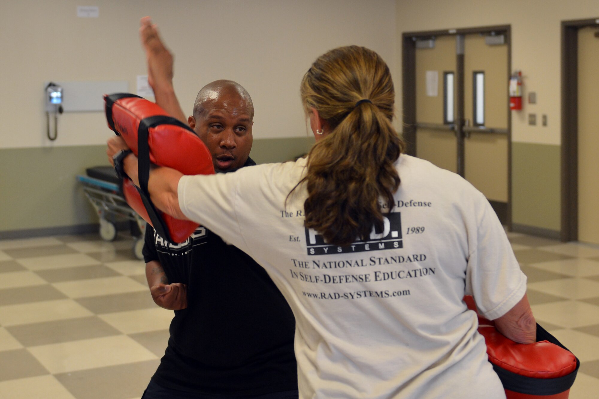 Senior Master Sgt. Daryl Hogan (left), 62nd Maintenance Squadron first sergeant, and Kathy Wright, R.A.D. (Rape, Aggression, Defense) Systems director of women’s programming, perform block and parry techniques, Sept., 9, 2013, at Clover Park Technical College, in Lakewood, Wash., during a R.A.D. Basic Physical Defense for Women Instructor Certification course. The block and parry techniques are used to help block and deflect an attacker’s punch to the victim’s head. (U.S. Air Force photo/Staff Sgt. Jason Truskowski)
